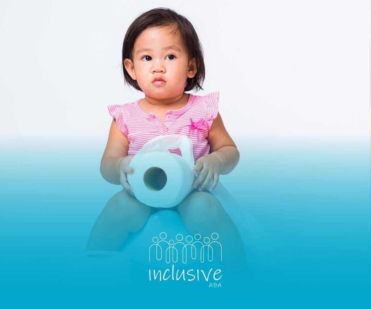 A little girl is sitting on a potty holding a roll of toilet paper after ABA therapy session.