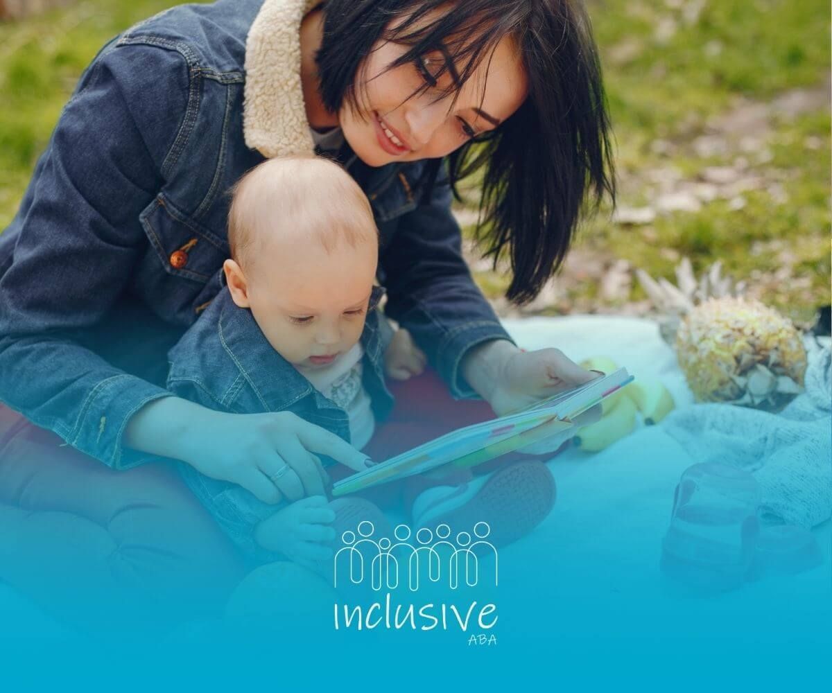 A BCBA is reading a book to a baby in ABA therapy.
