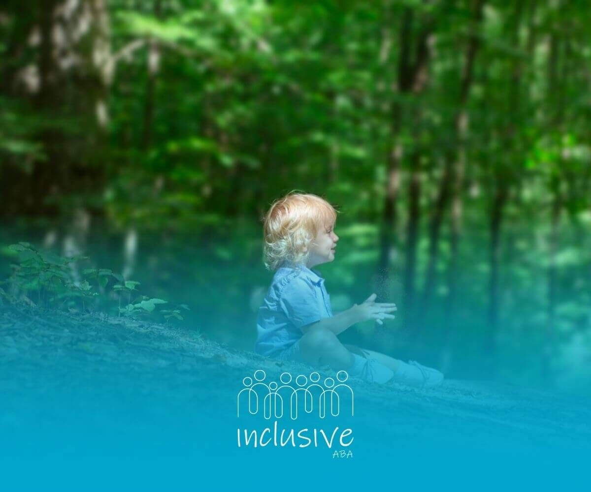An autistic young child playing alone in a forest, sitting and enjoying nature after ABA therapy.