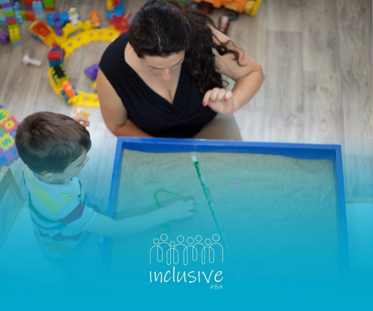A woman is playing with a child in a sandbox.