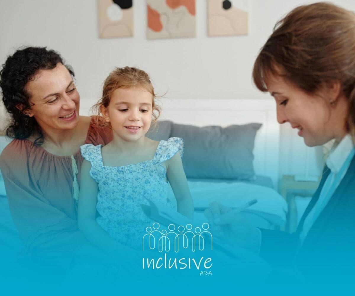 A child and mother smile as they work with a therapist taking notes during ABA therapy.