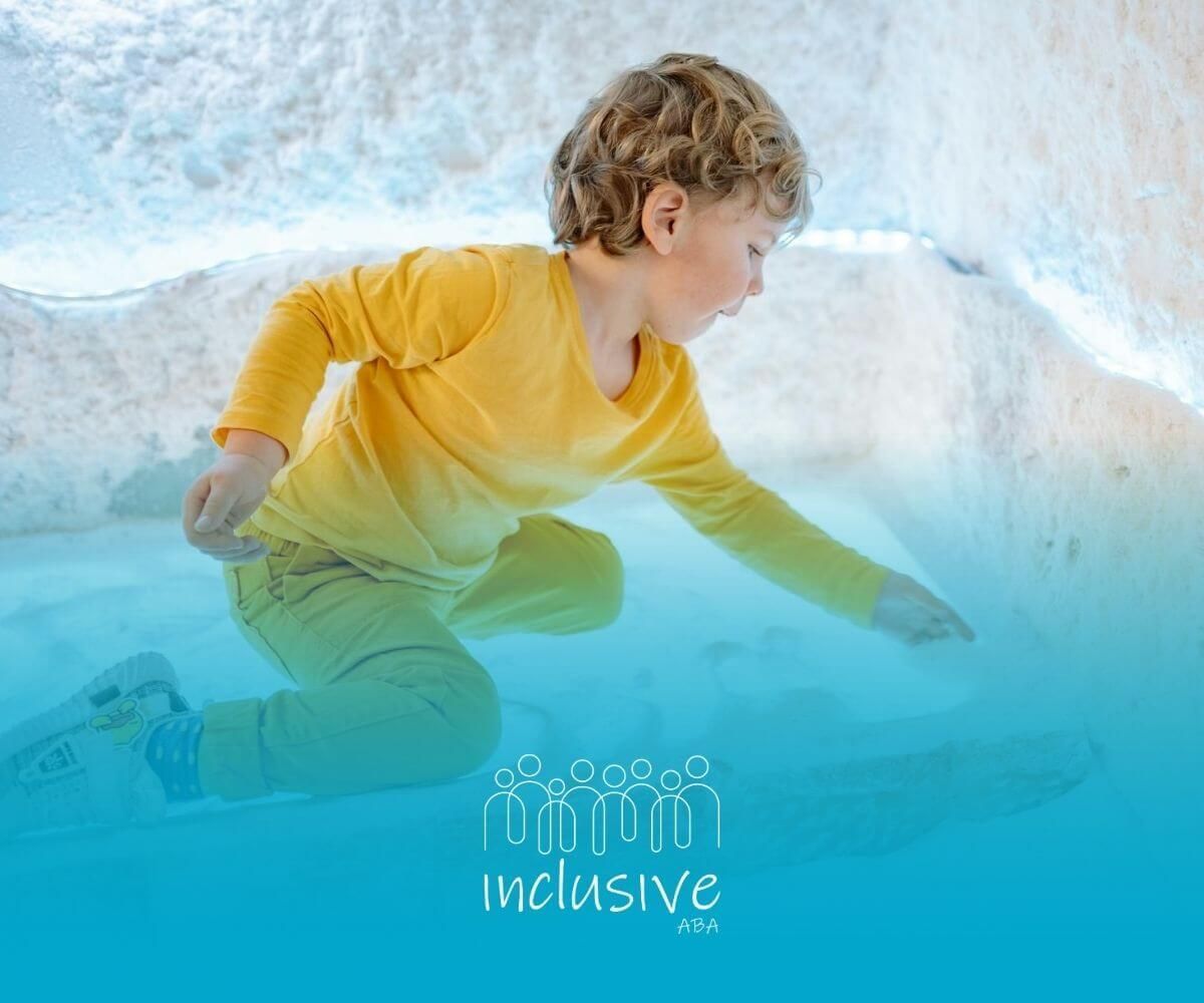 An autistic child in yellow outfit playing in a bright salt room after ABA therapy in Nebraska.