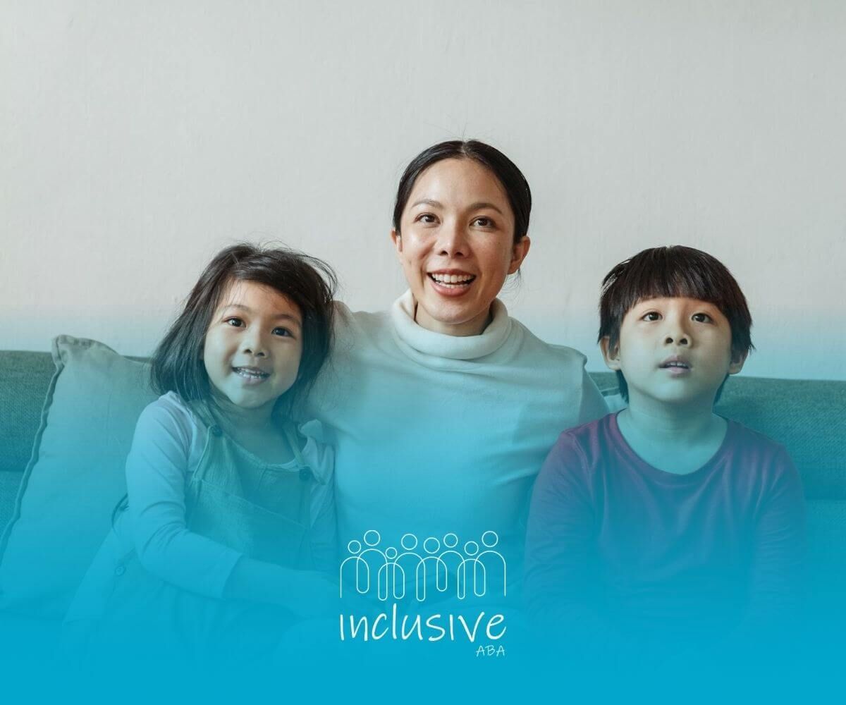 Smiling ABA therapist sitting on couch with two young children after ABA Therapy in Nevada.