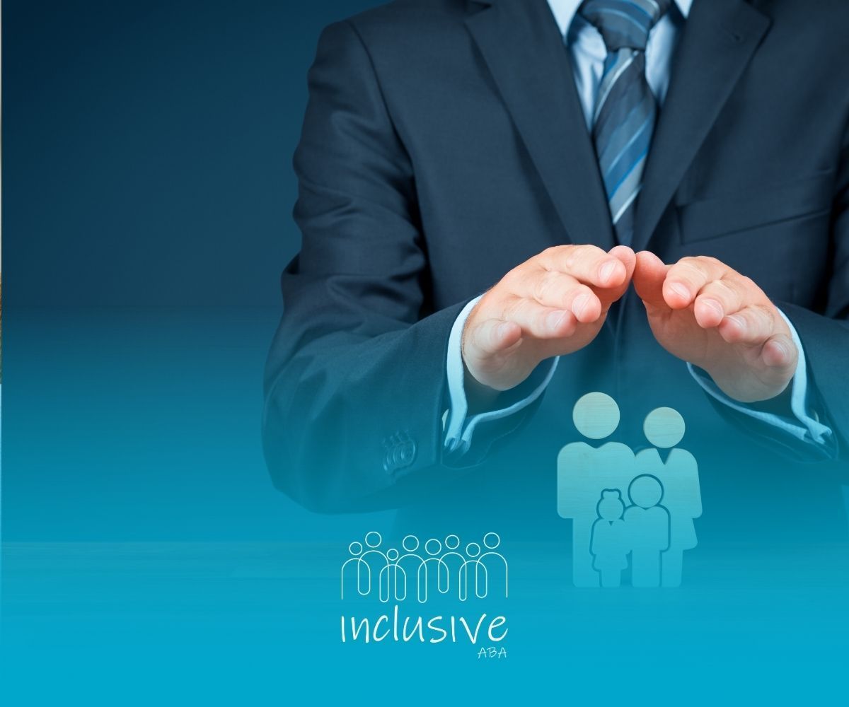 Businessperson shielding paper family figures on a desk, symbolizing protection and insurance