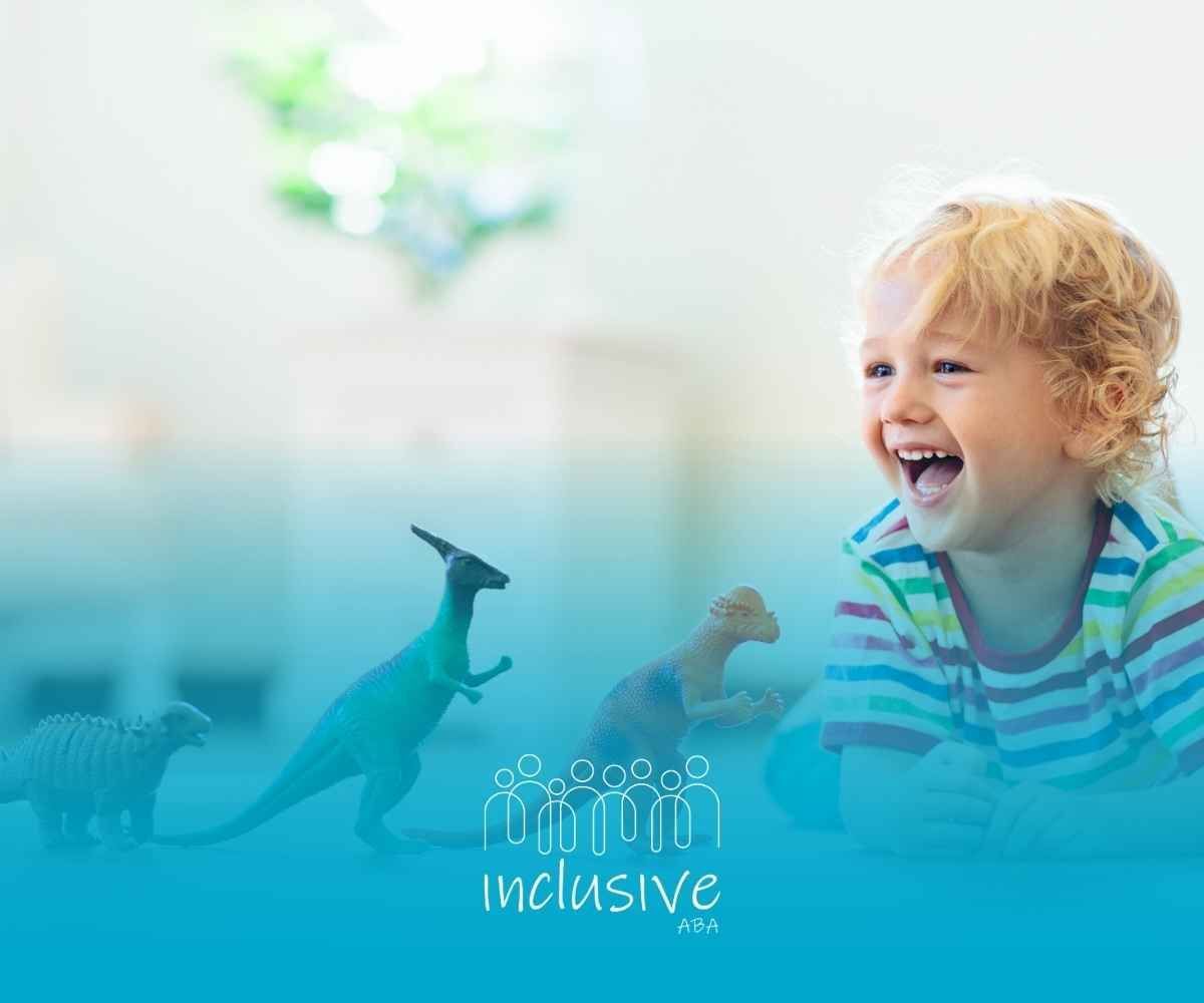 A smiling child with blond hair, wearing a striped shirt, playing with colorful dinosaur