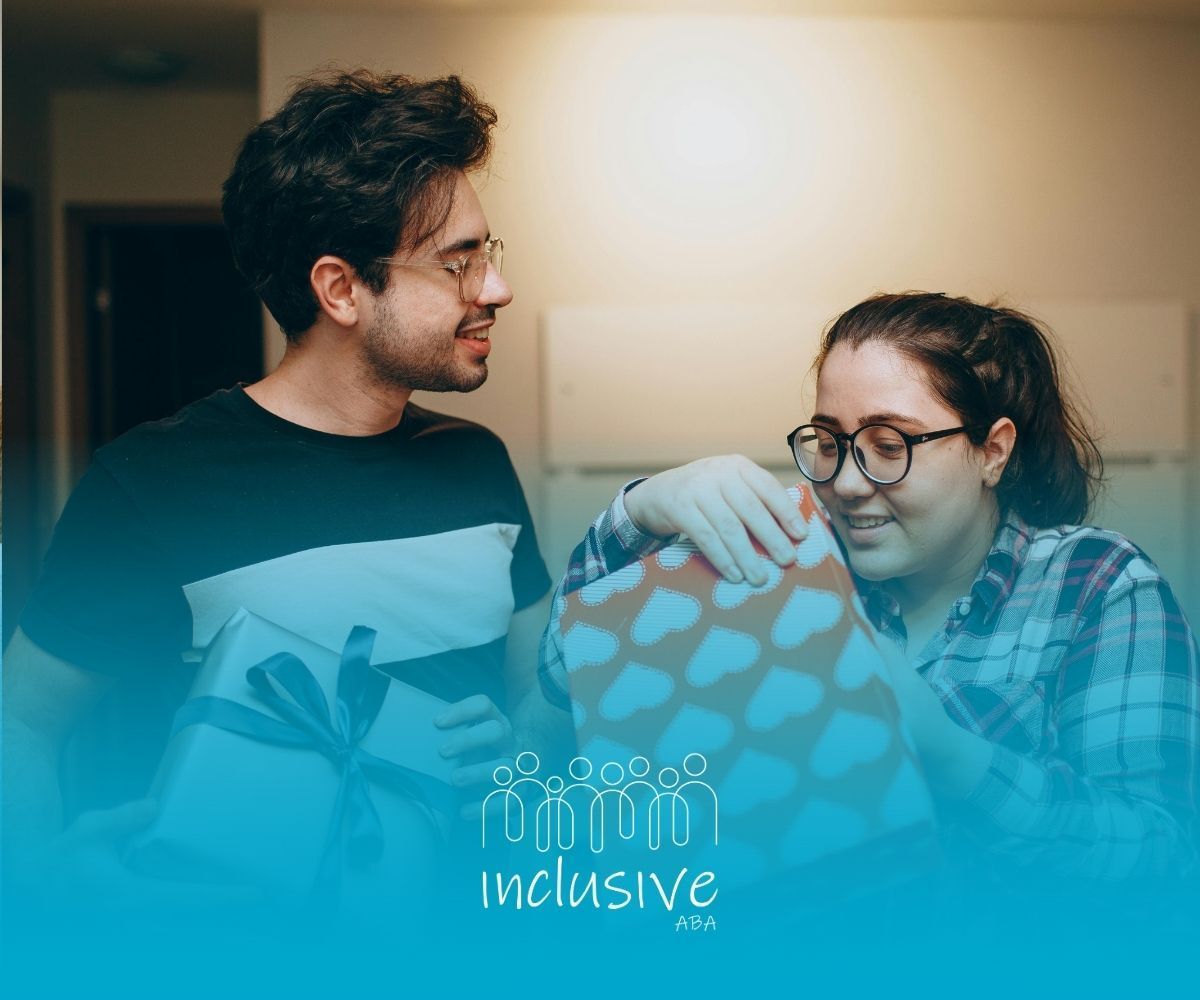 Two people holding wrapped gifts while smiling at each other in an indoor setting, with a bottom brand logo overlay.