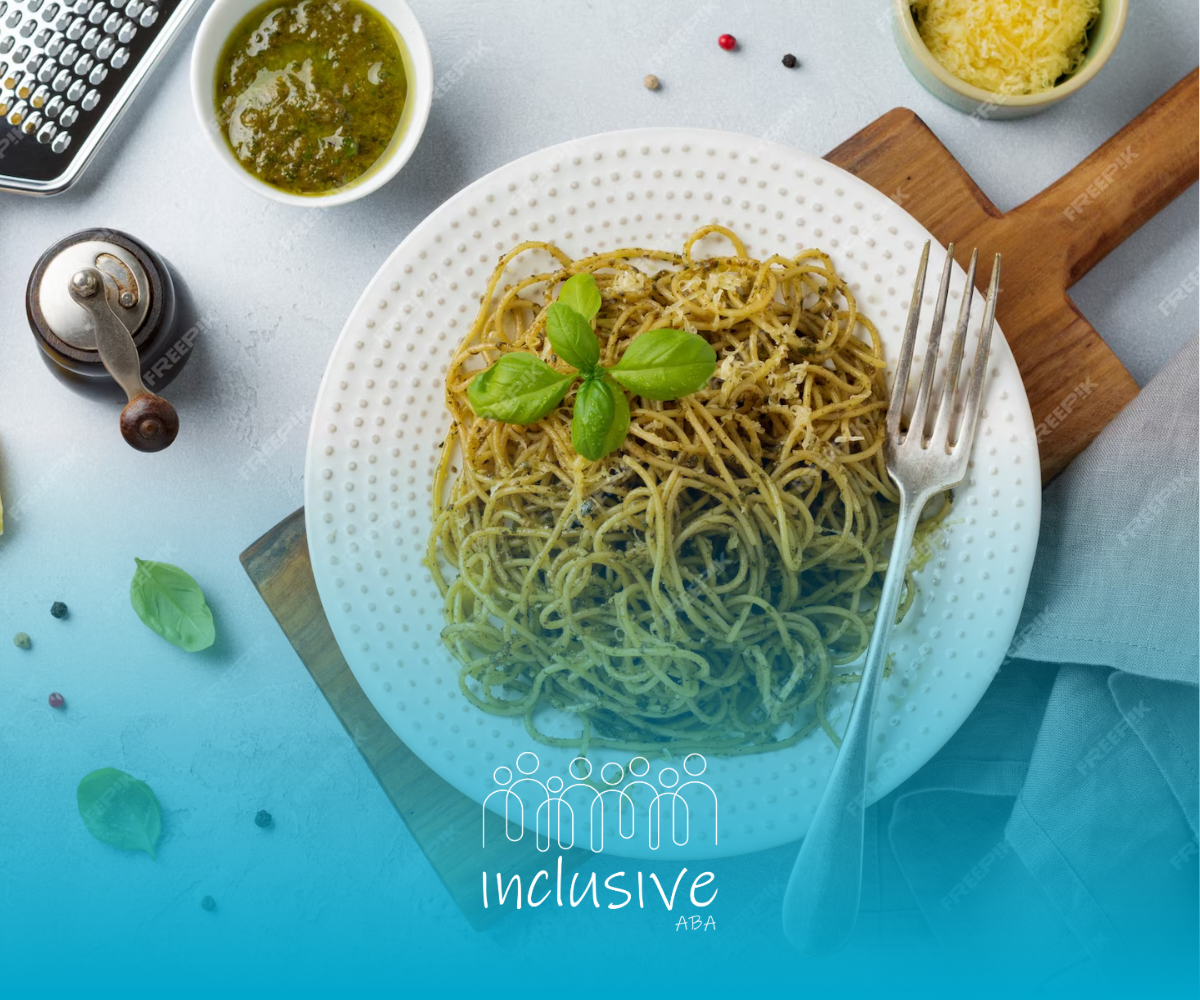 A plate of noodles and basil with a fork on a table.