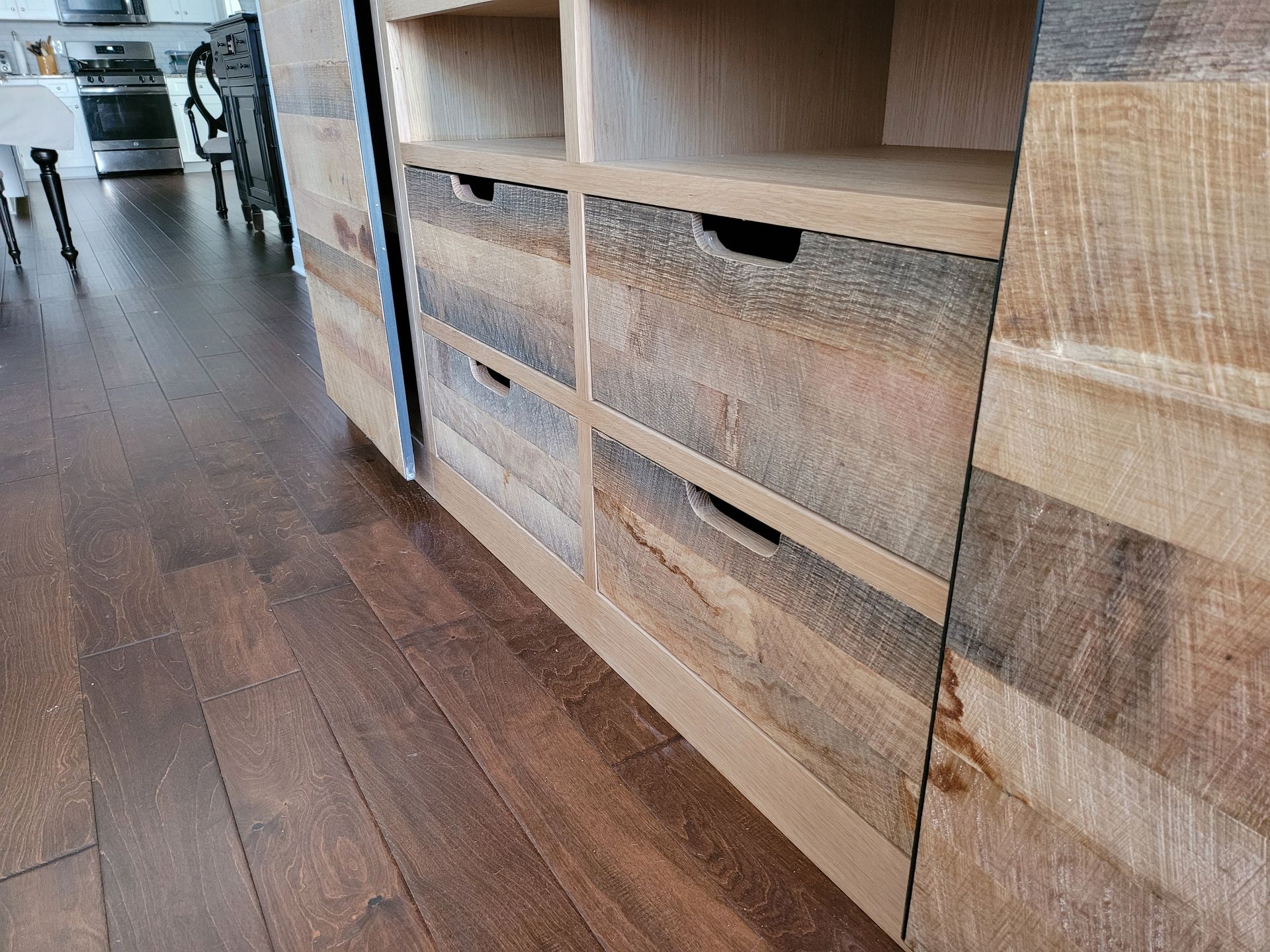 A wooden cabinet with drawers and shelves in a kitchen.