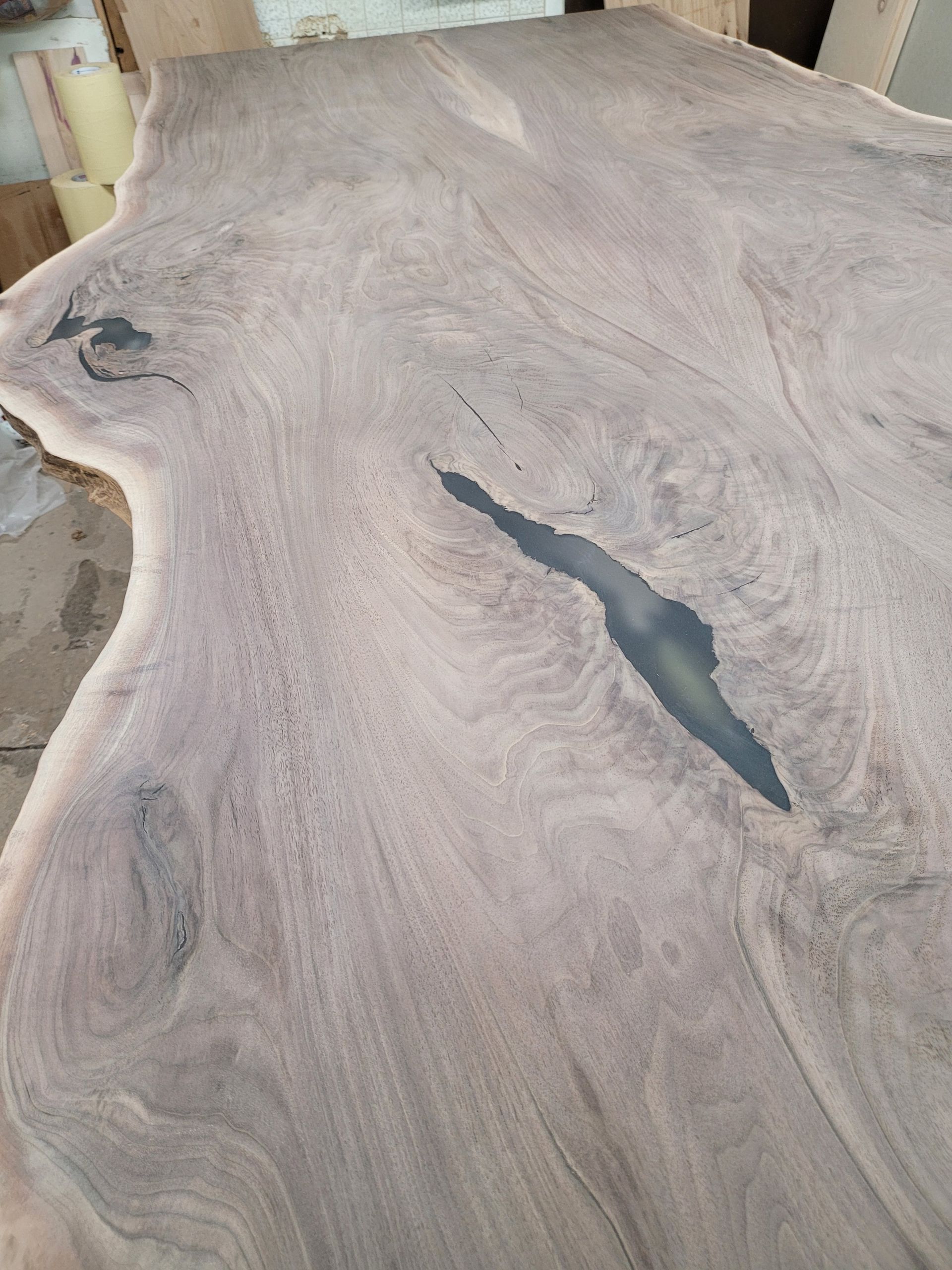 A large piece of wood with a hole in it is sitting on a table.