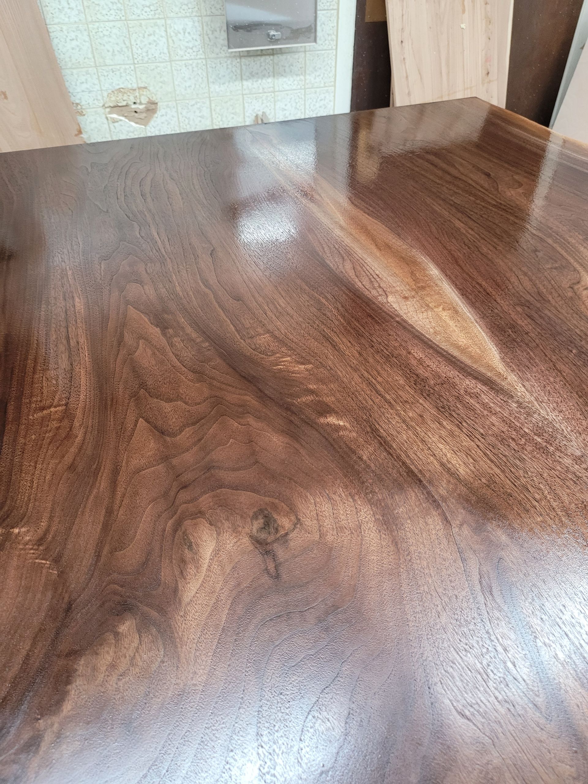 A close up of a wooden table with a shiny finish.