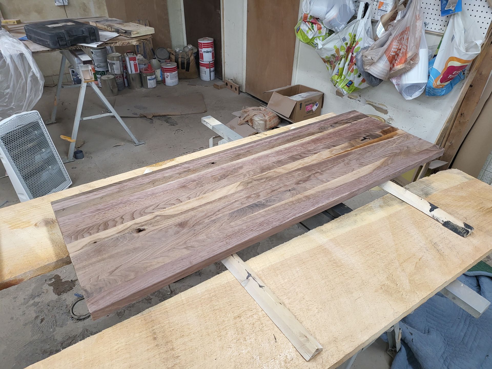 A piece of wood is sitting on top of a wooden table.