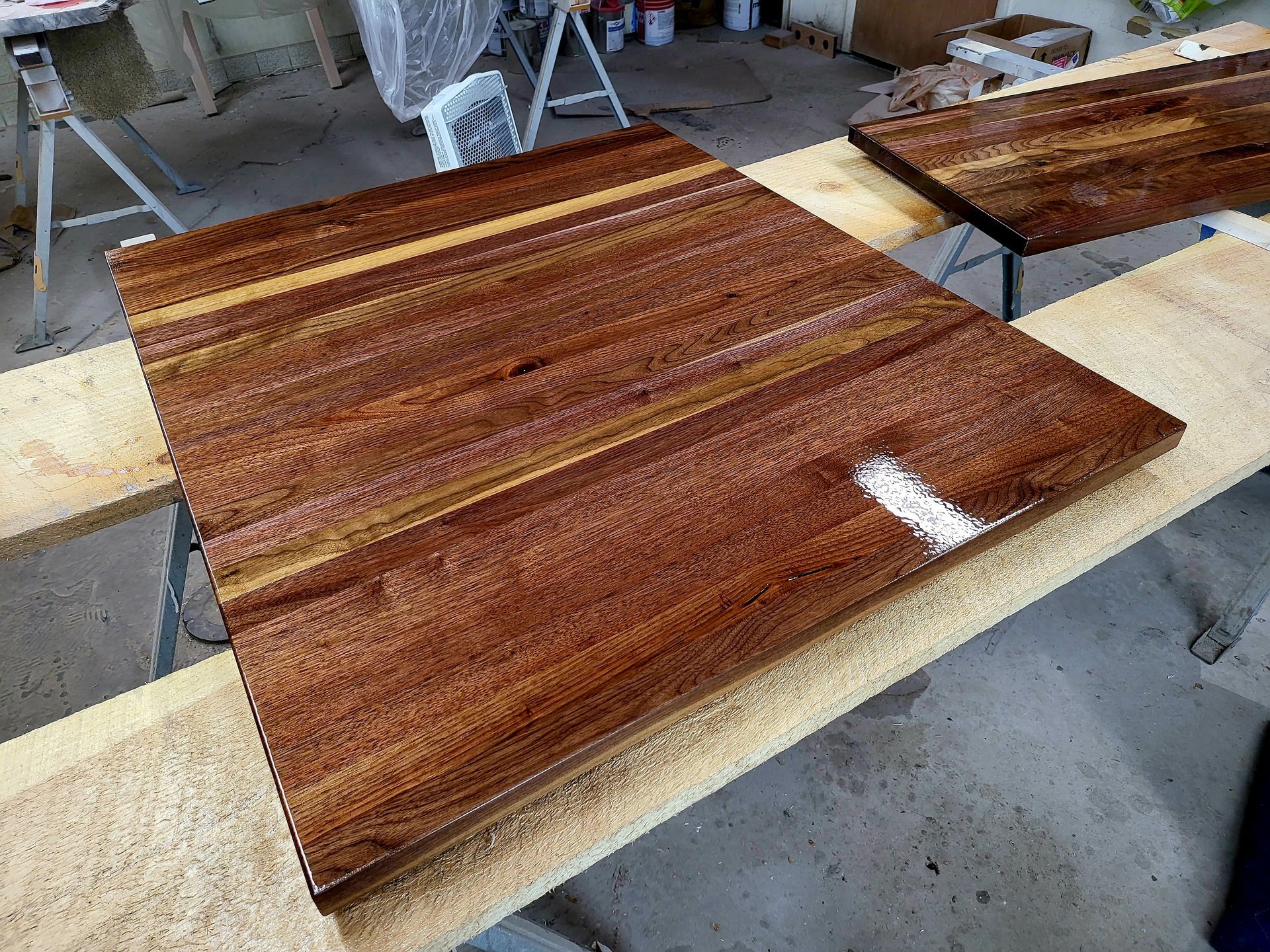 A piece of wood is sitting on top of a wooden table.