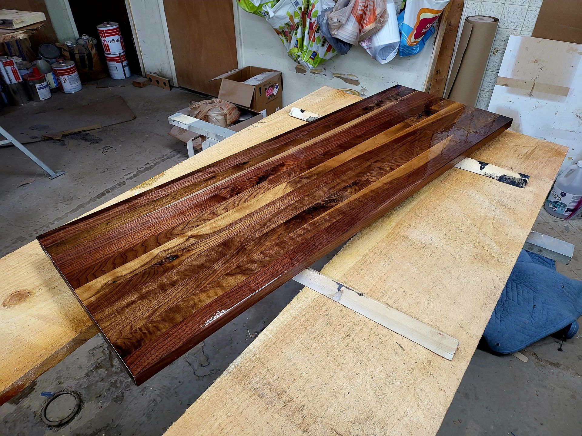 A piece of wood is sitting on top of a wooden table.