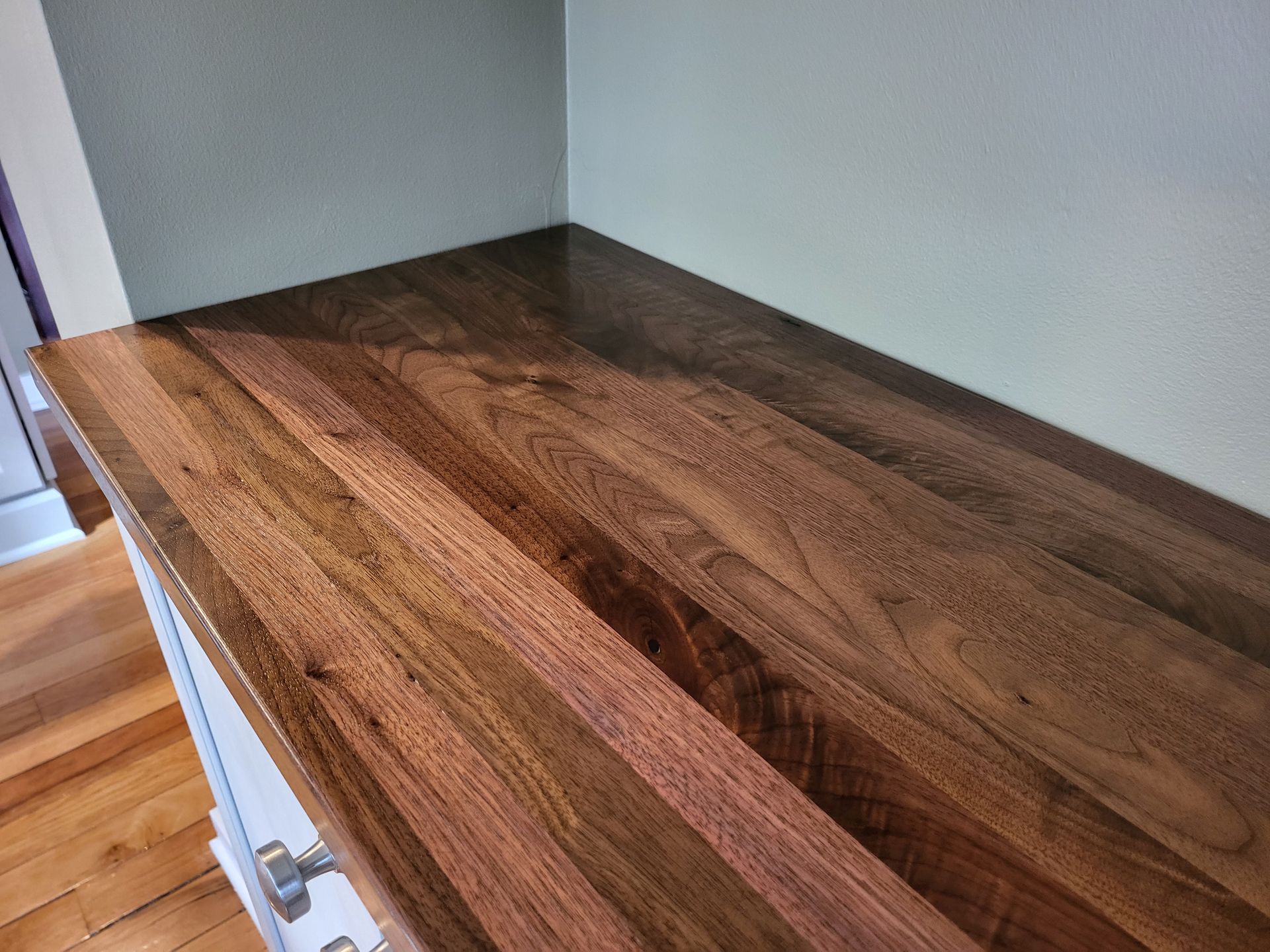 A close up of a wooden counter top in a kitchen.