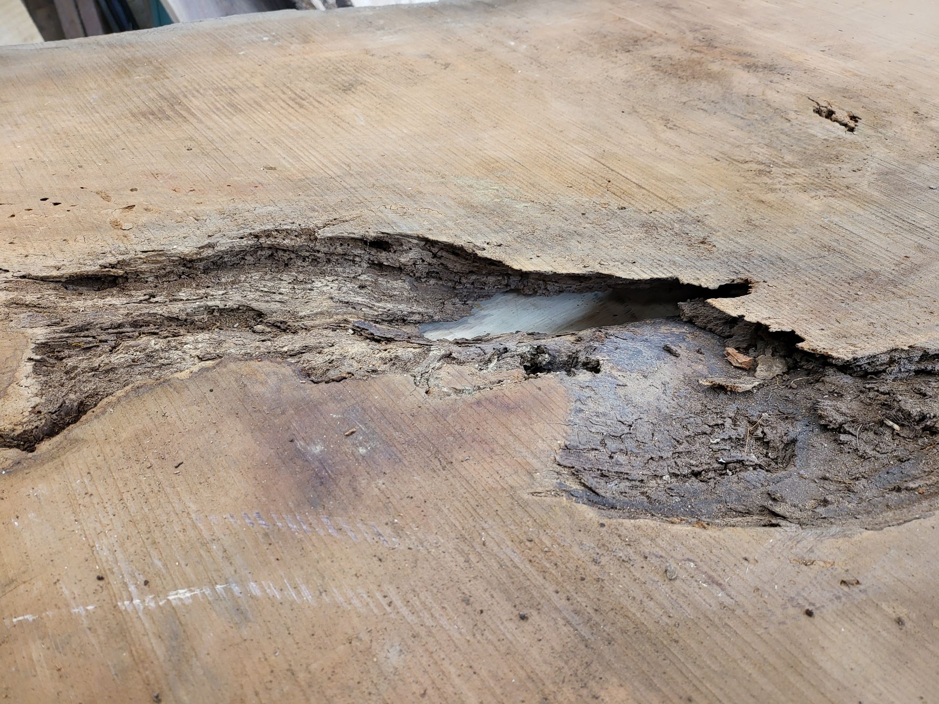A close up of a piece of wood with a hole in it.