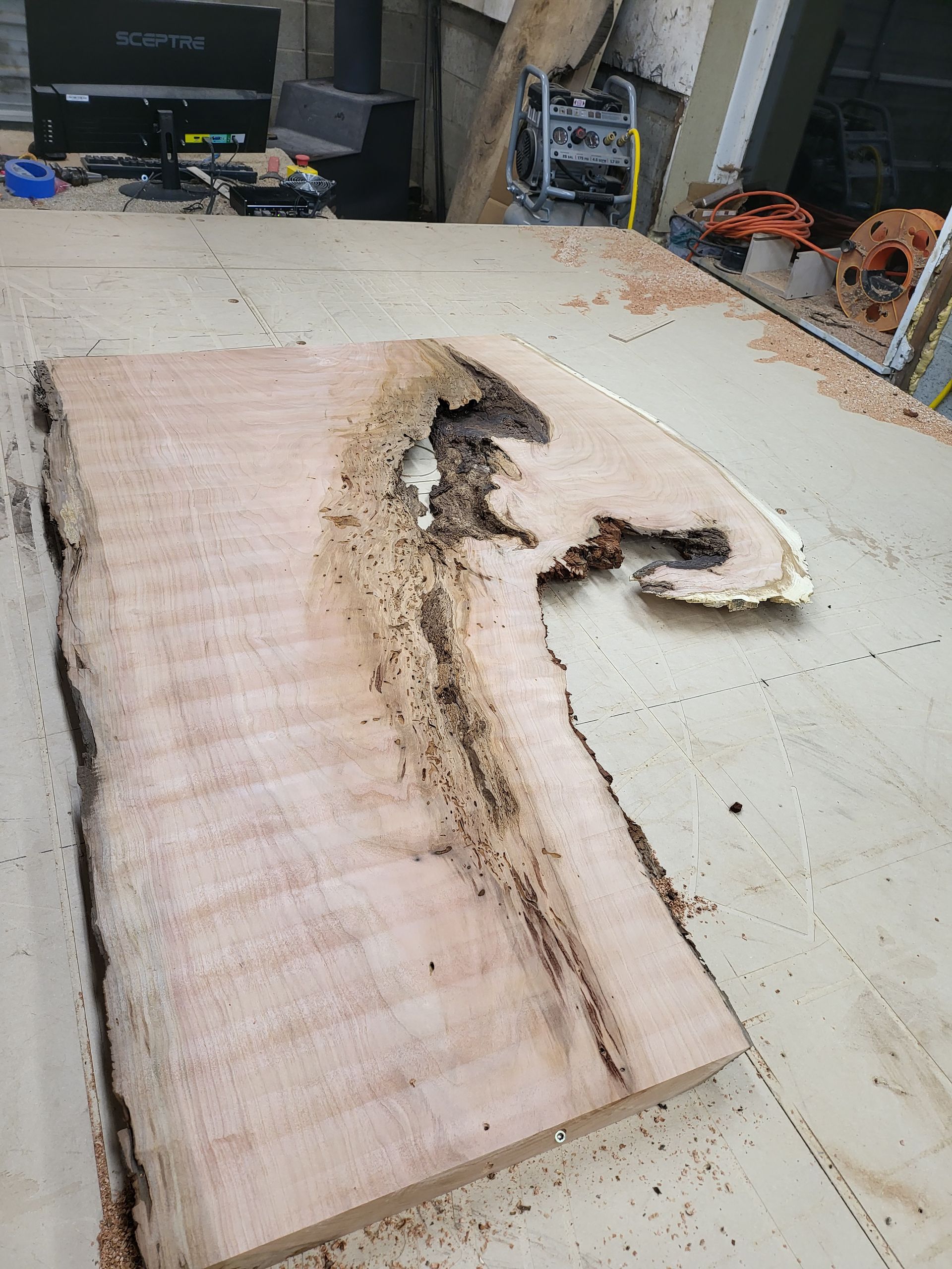 A piece of wood with a hole in it is sitting on a table.