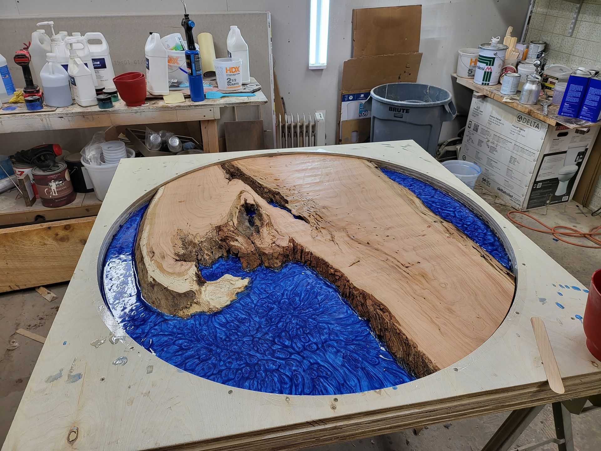 A piece of wood is sitting on top of a table in a room.