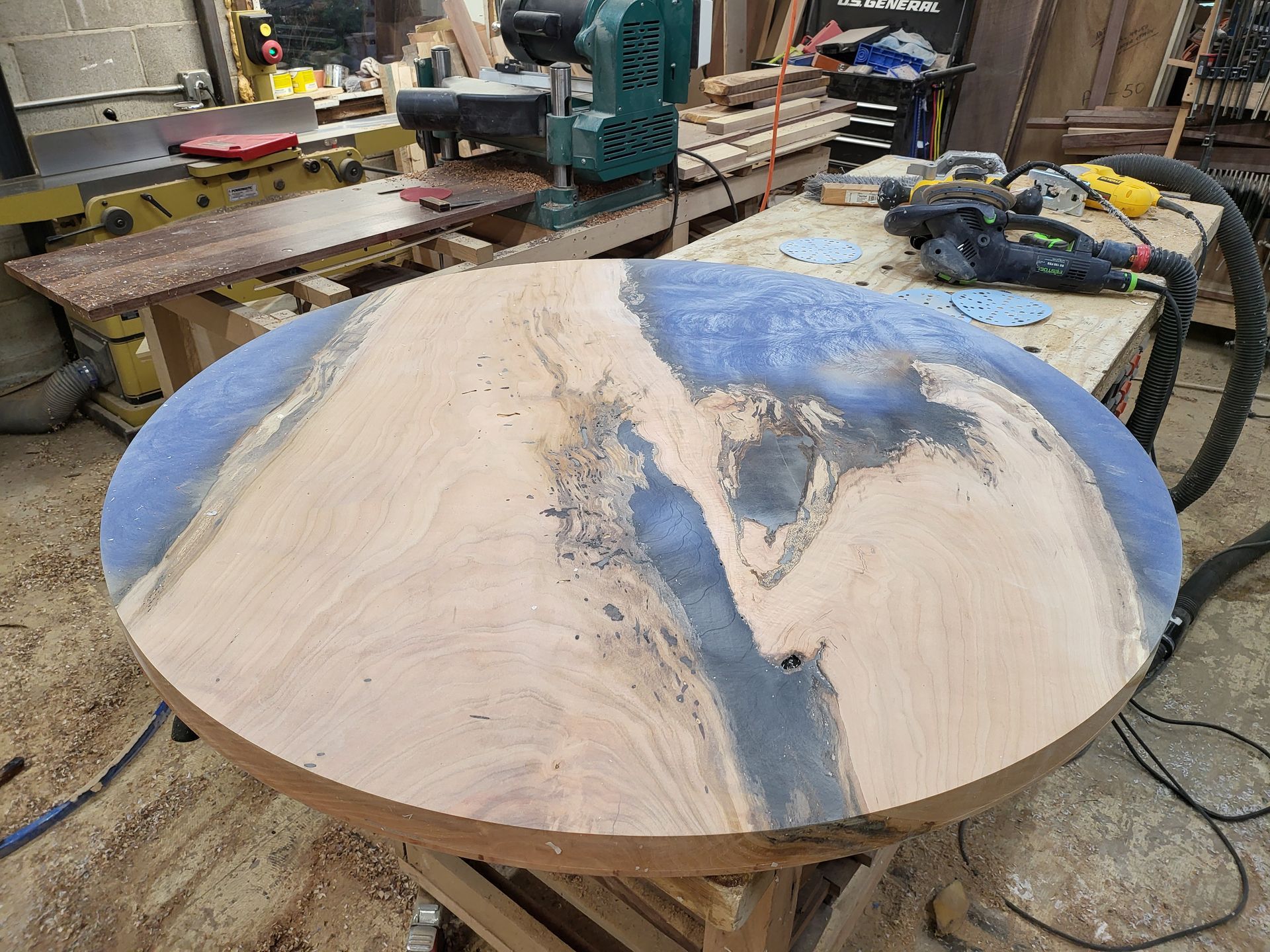 A wooden table is being made in a workshop.