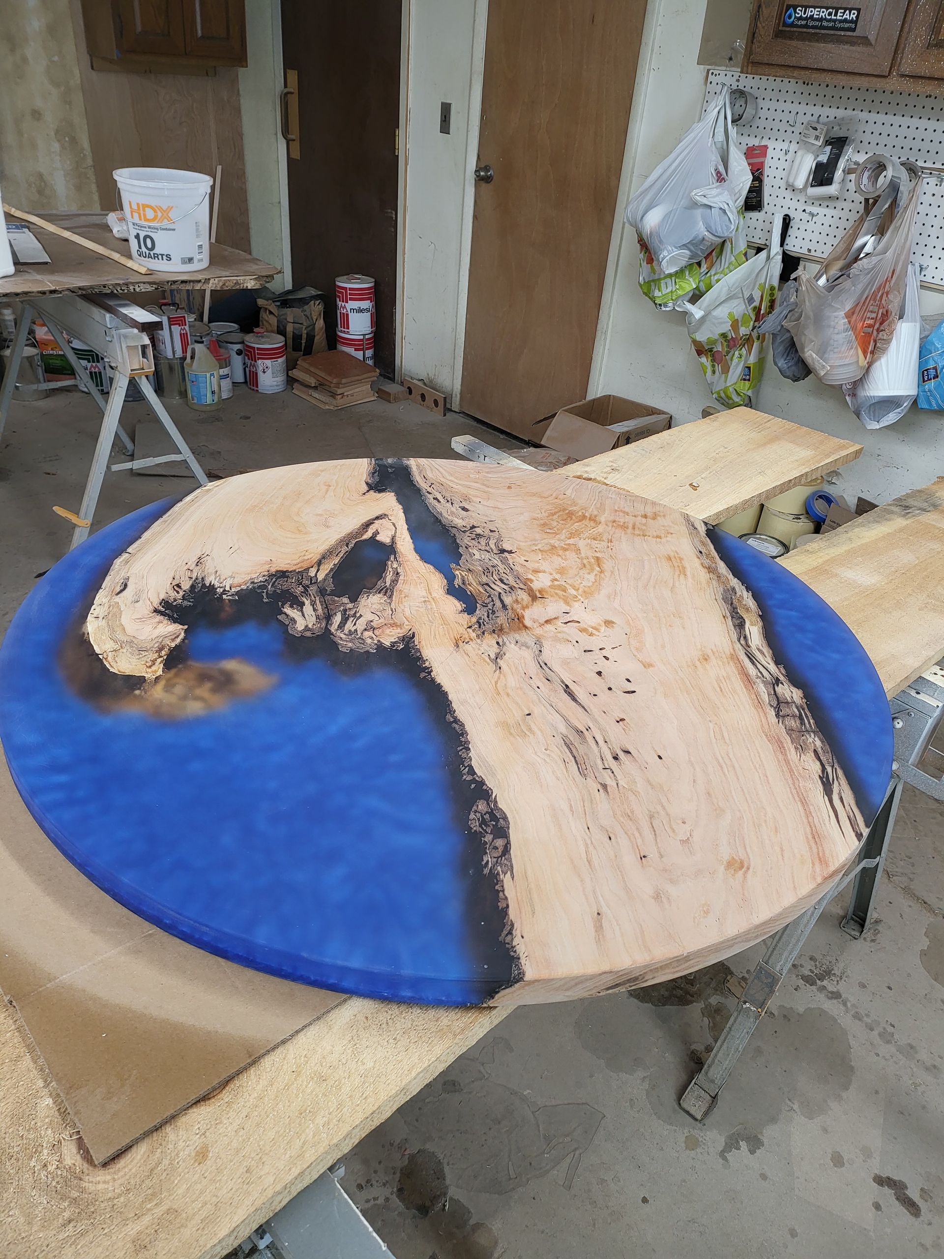 A piece of wood is sitting on top of a wooden table.