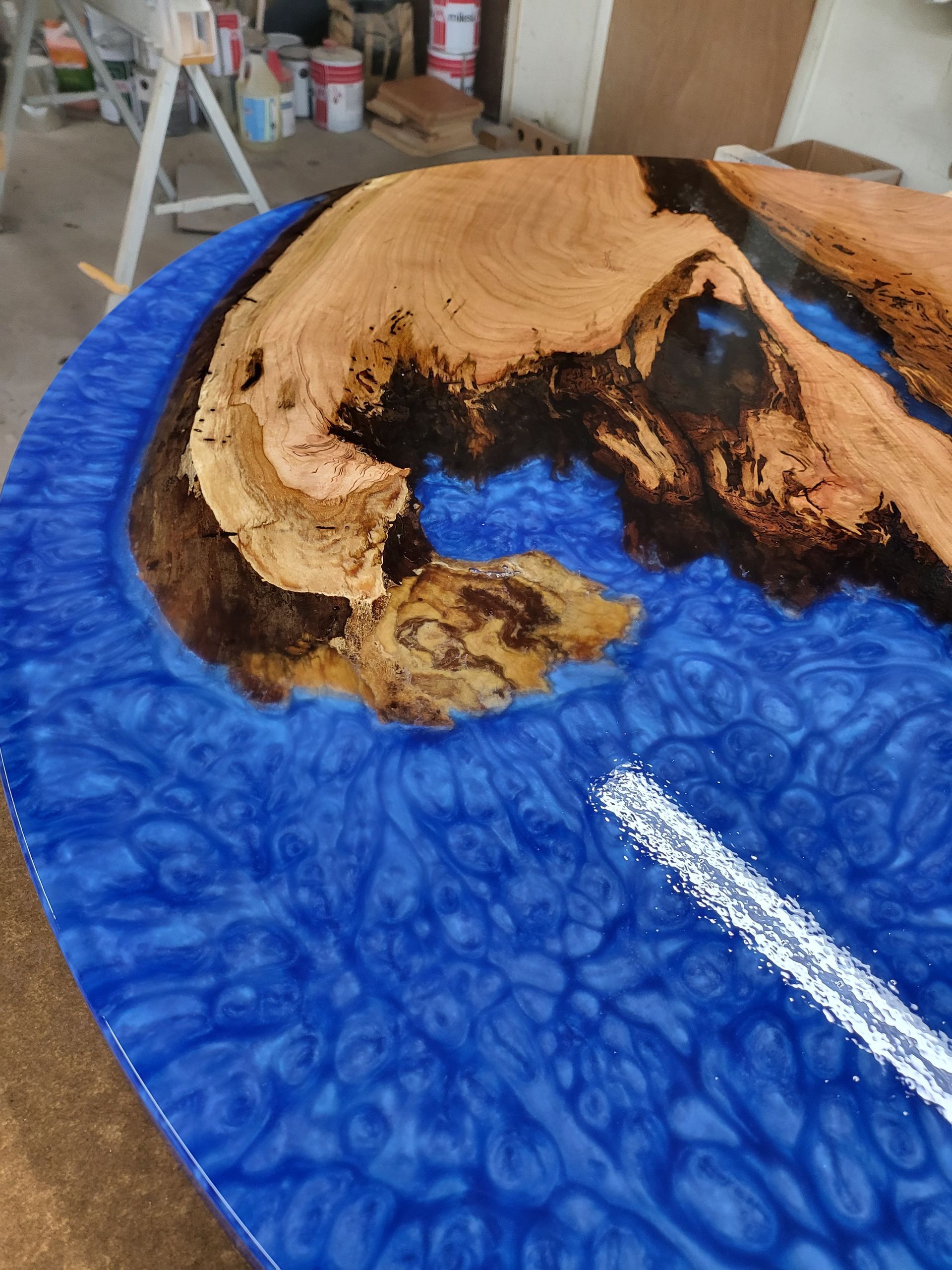 A piece of wood is sitting on top of a blue plate.