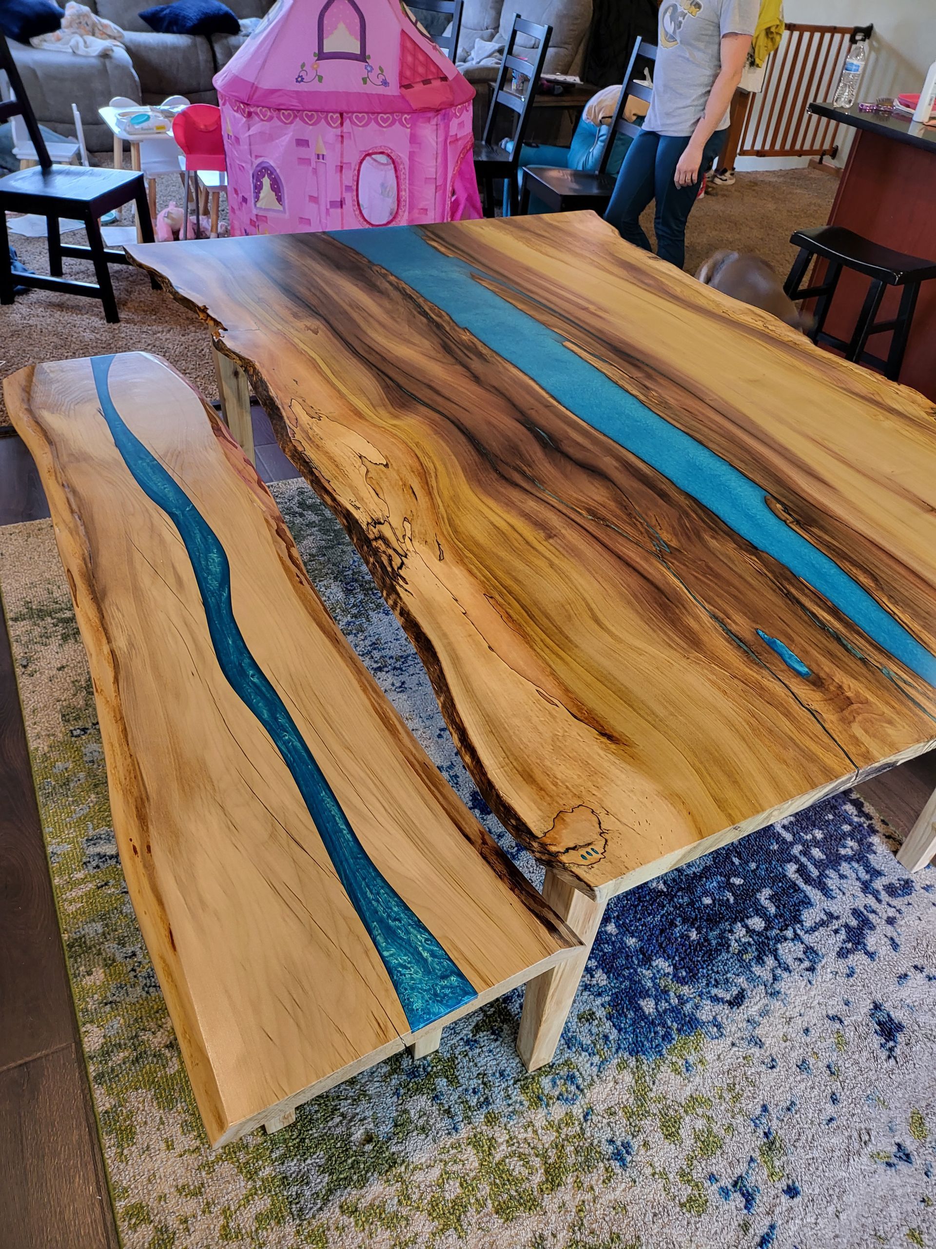 A wooden table with a blue river in the middle of it.