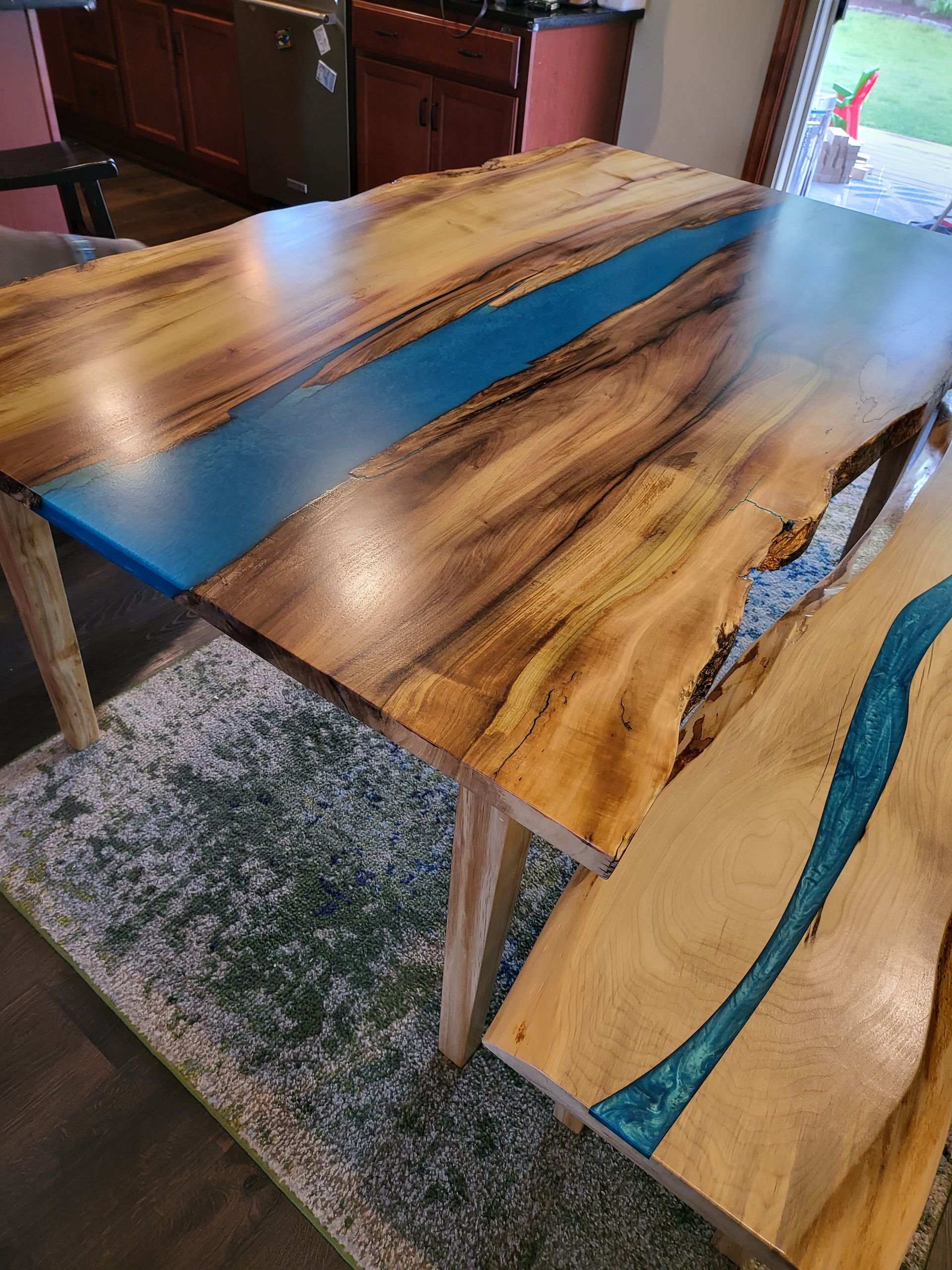 A wooden table with a blue river in the middle of it.
