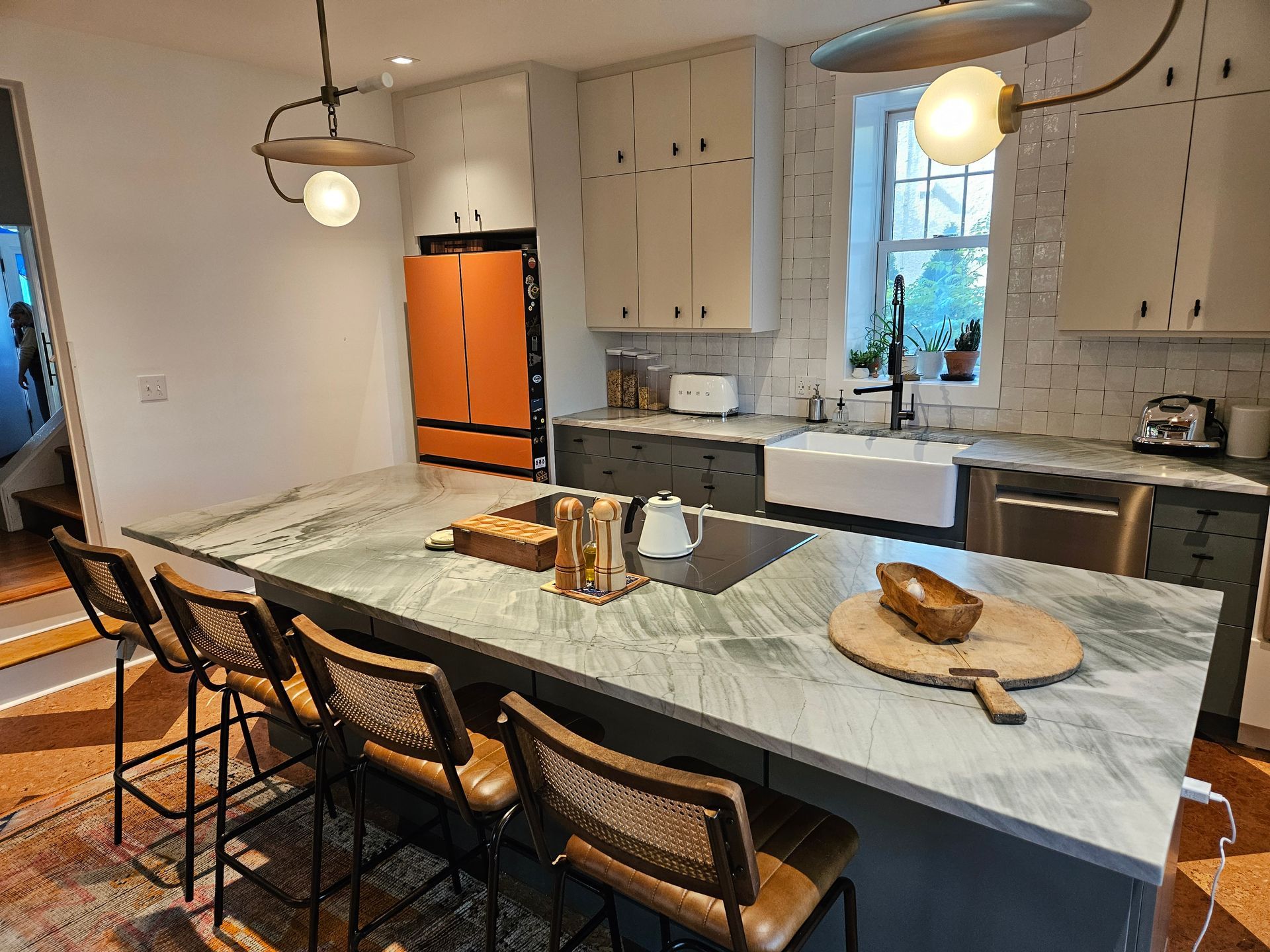 A kitchen with a large island and a sink.