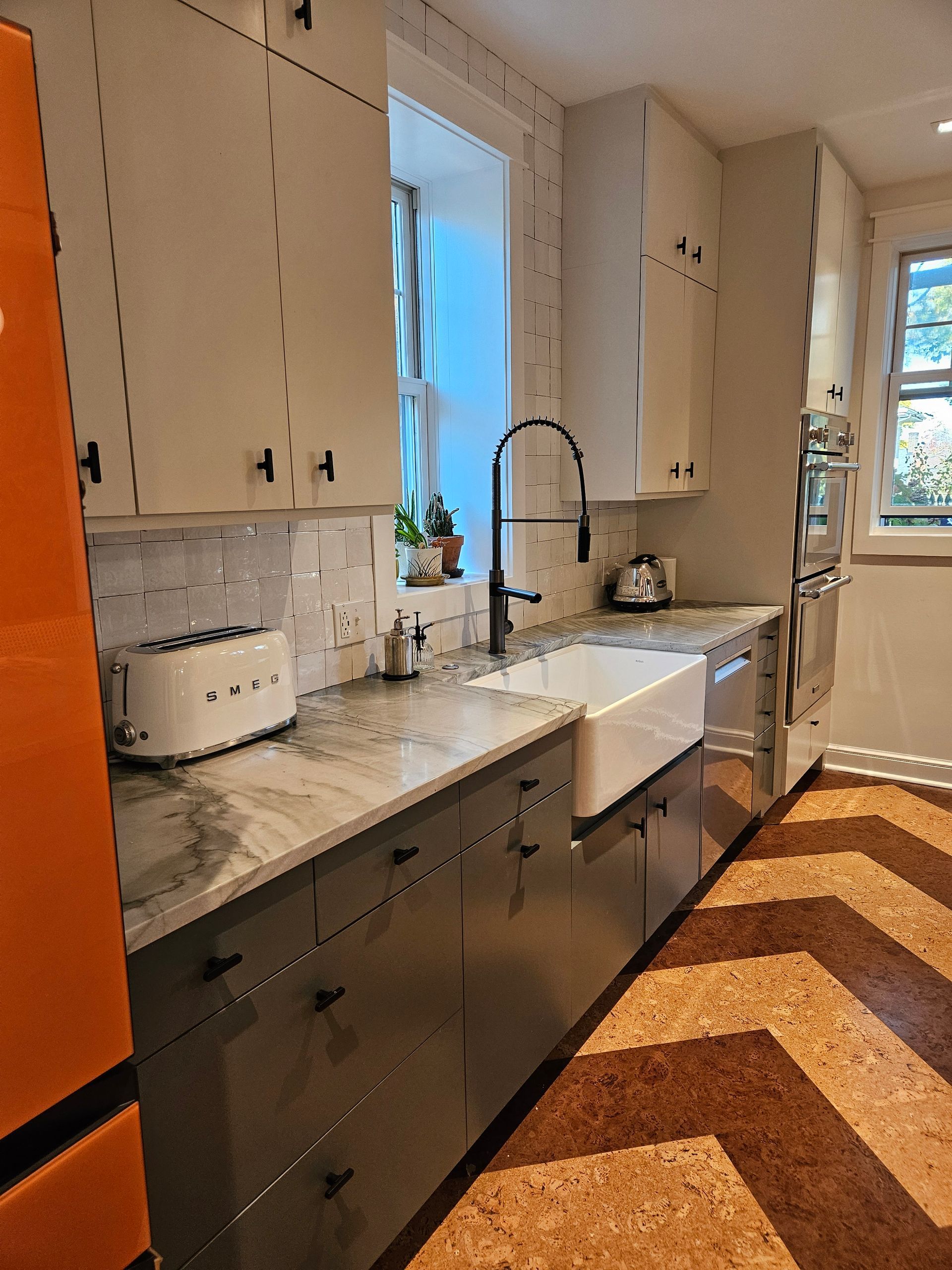 A kitchen with a sink and a toaster oven