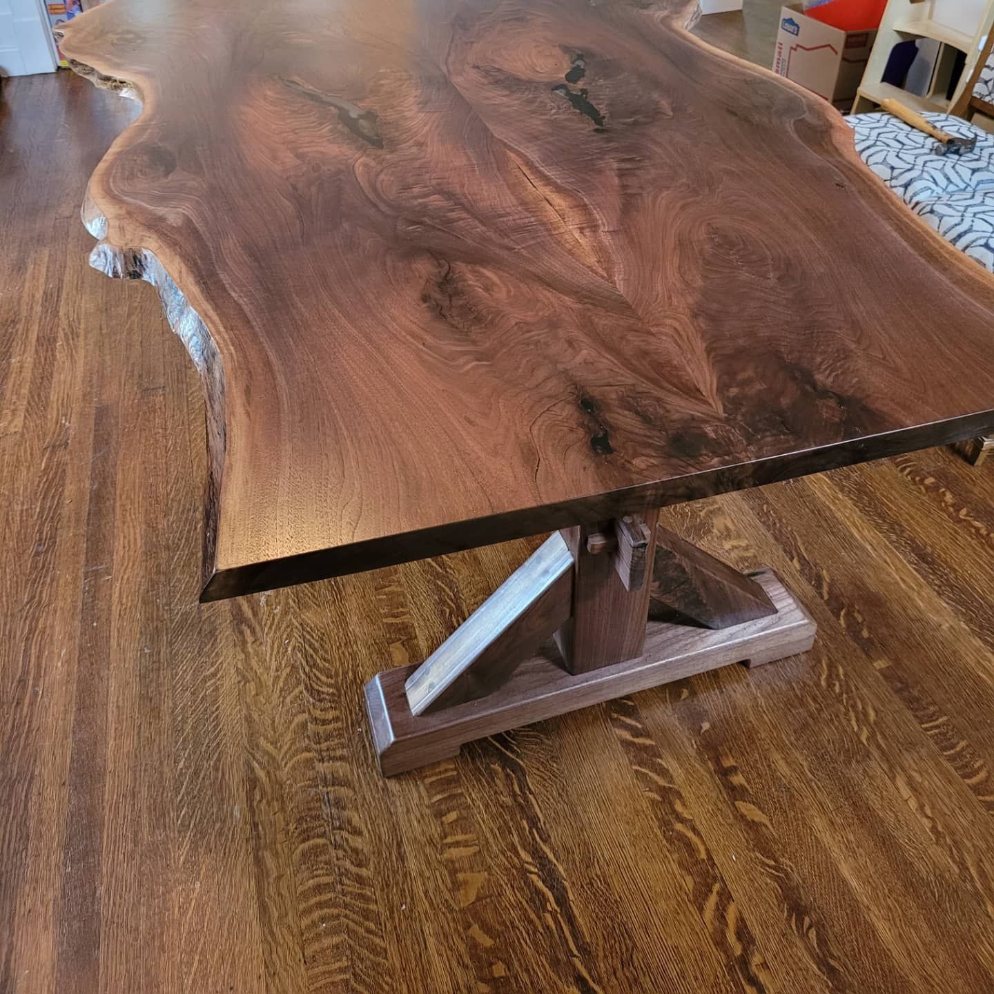 A wooden table is sitting on a wooden floor.