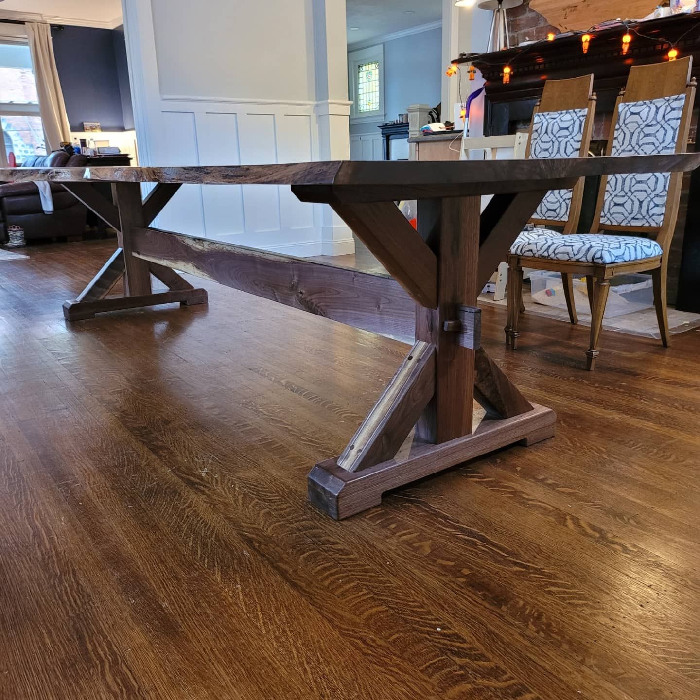 A wooden table is sitting on a wooden floor in a living room.