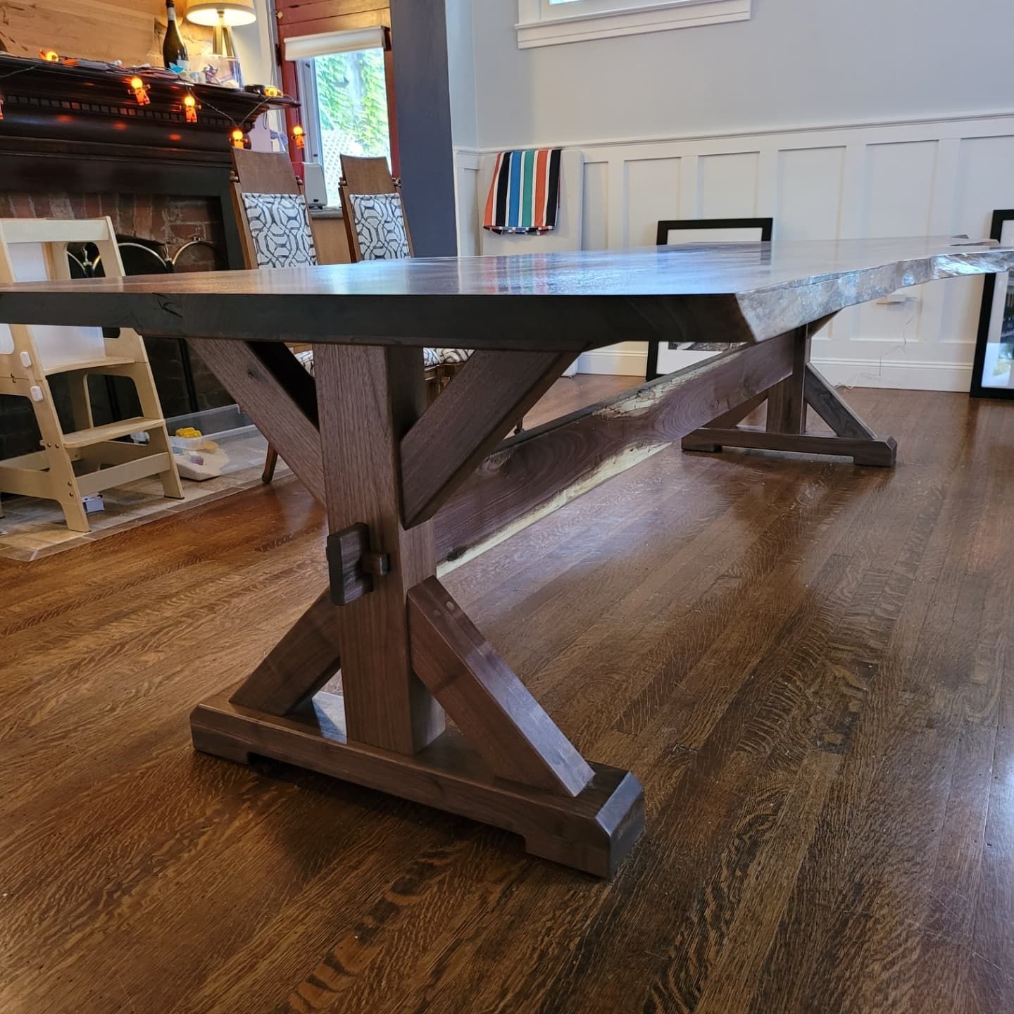 A wooden table is sitting on a wooden floor in a living room.
