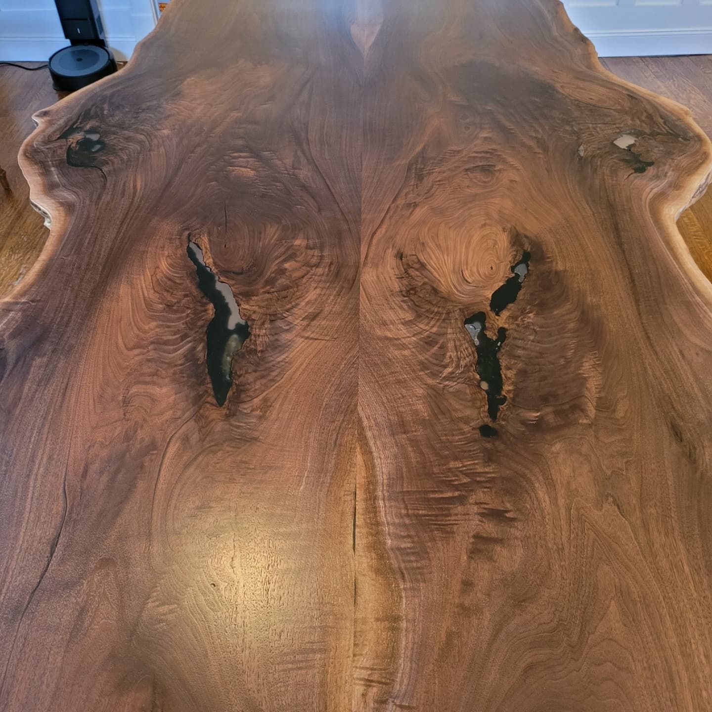 A close up of a wooden table with a hole in the middle.