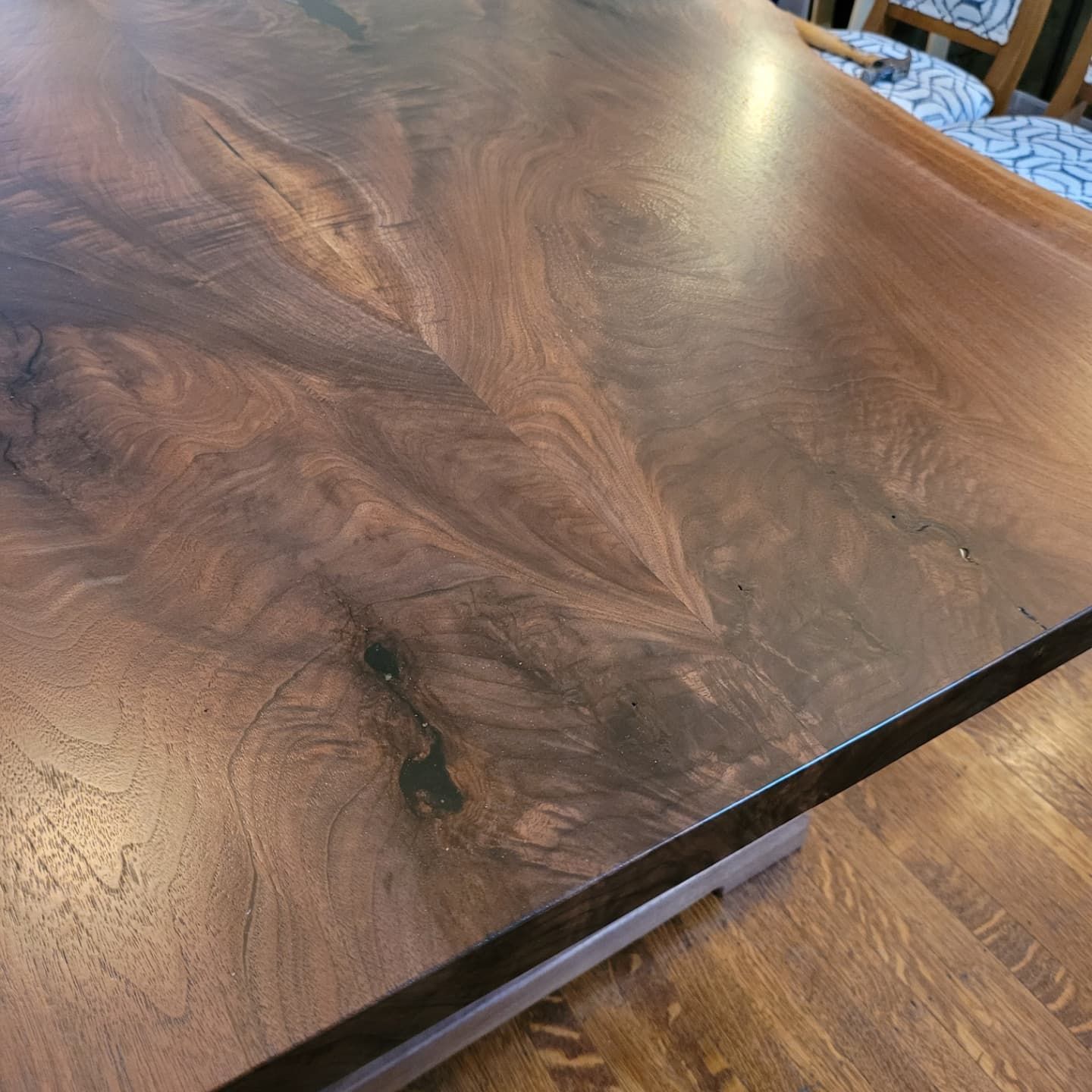 A wooden table is sitting on a wooden floor.