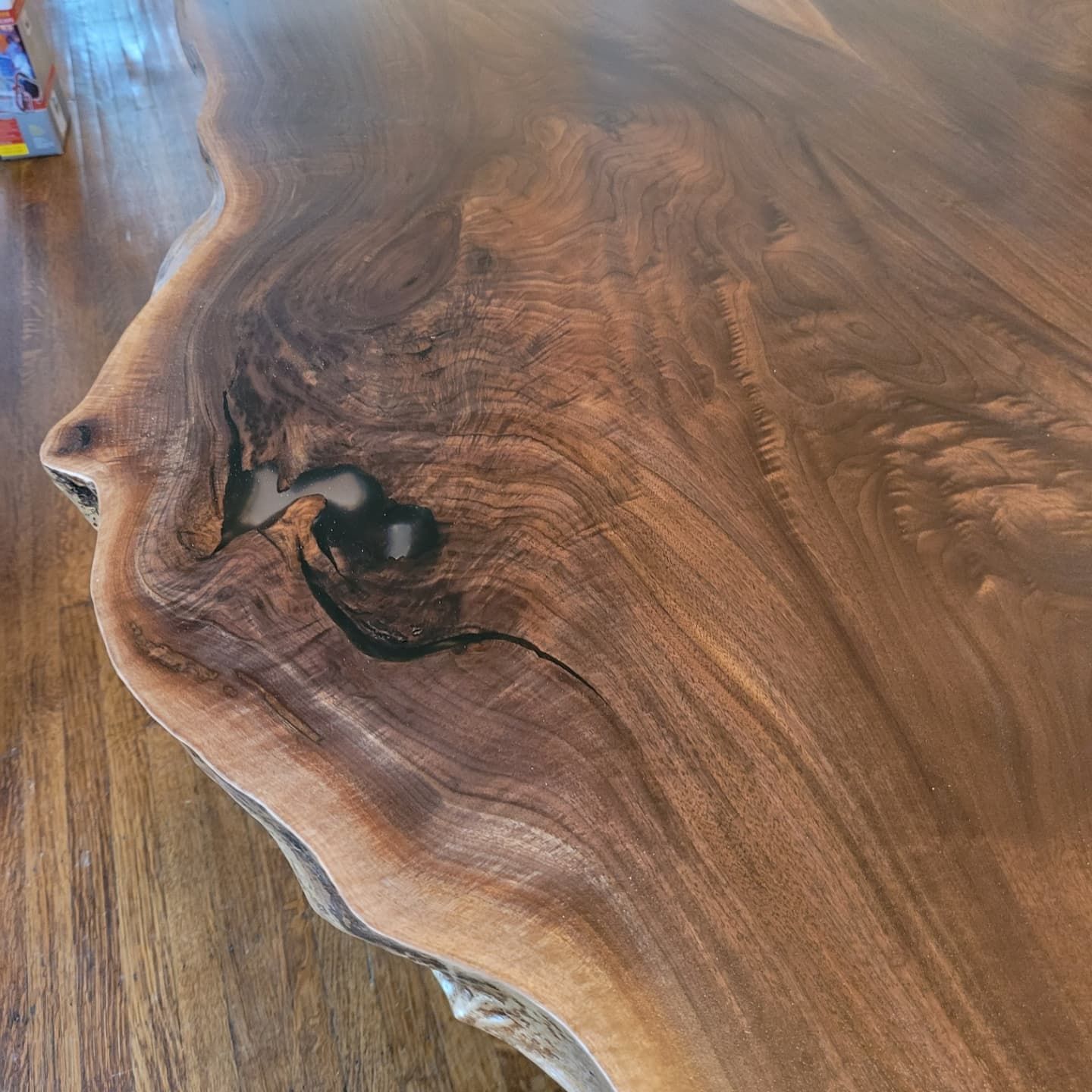 A close up of a piece of wood on a wooden floor.