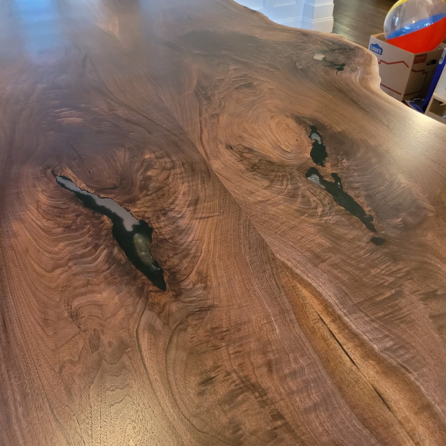 A close up of a wooden table with a hole in it.