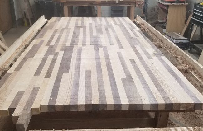 A wooden table is being made in a workshop.