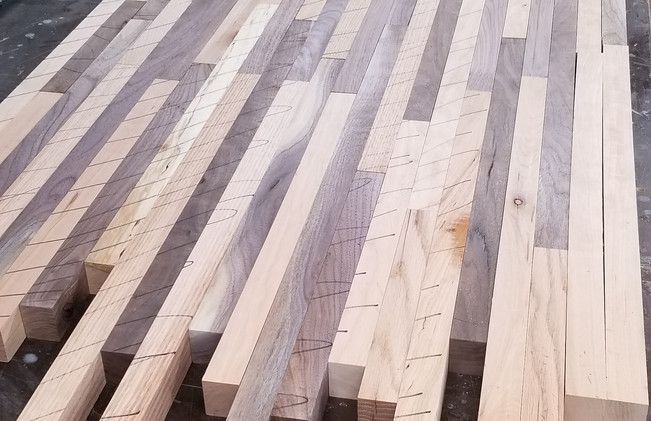A bunch of wood pieces are lined up on a table
