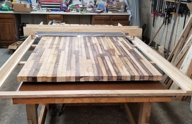 A large piece of wood is sitting on top of a wooden table.