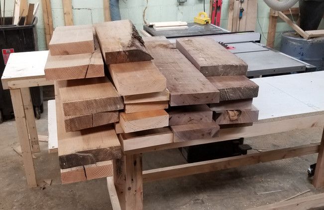 A pile of wood is sitting on top of a wooden table.