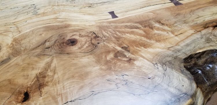 A close up of a piece of wood with a hole in it.