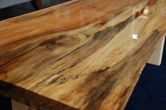 A close up of a wooden table with a shiny finish