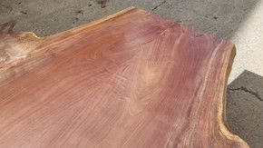 A piece of wood is sitting on top of a concrete surface.