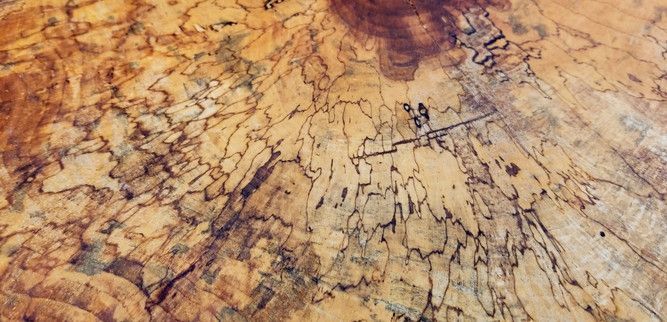 A close up of a piece of wood with a marble texture.