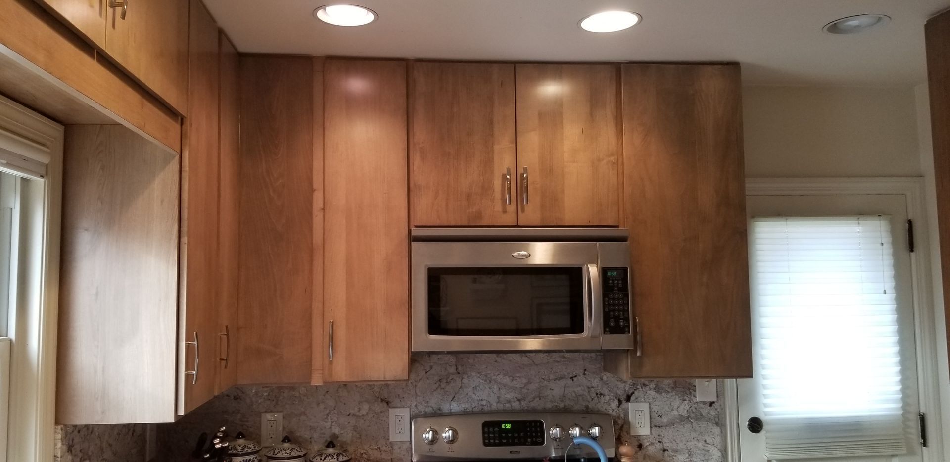 A kitchen with stainless steel appliances and wooden cabinets