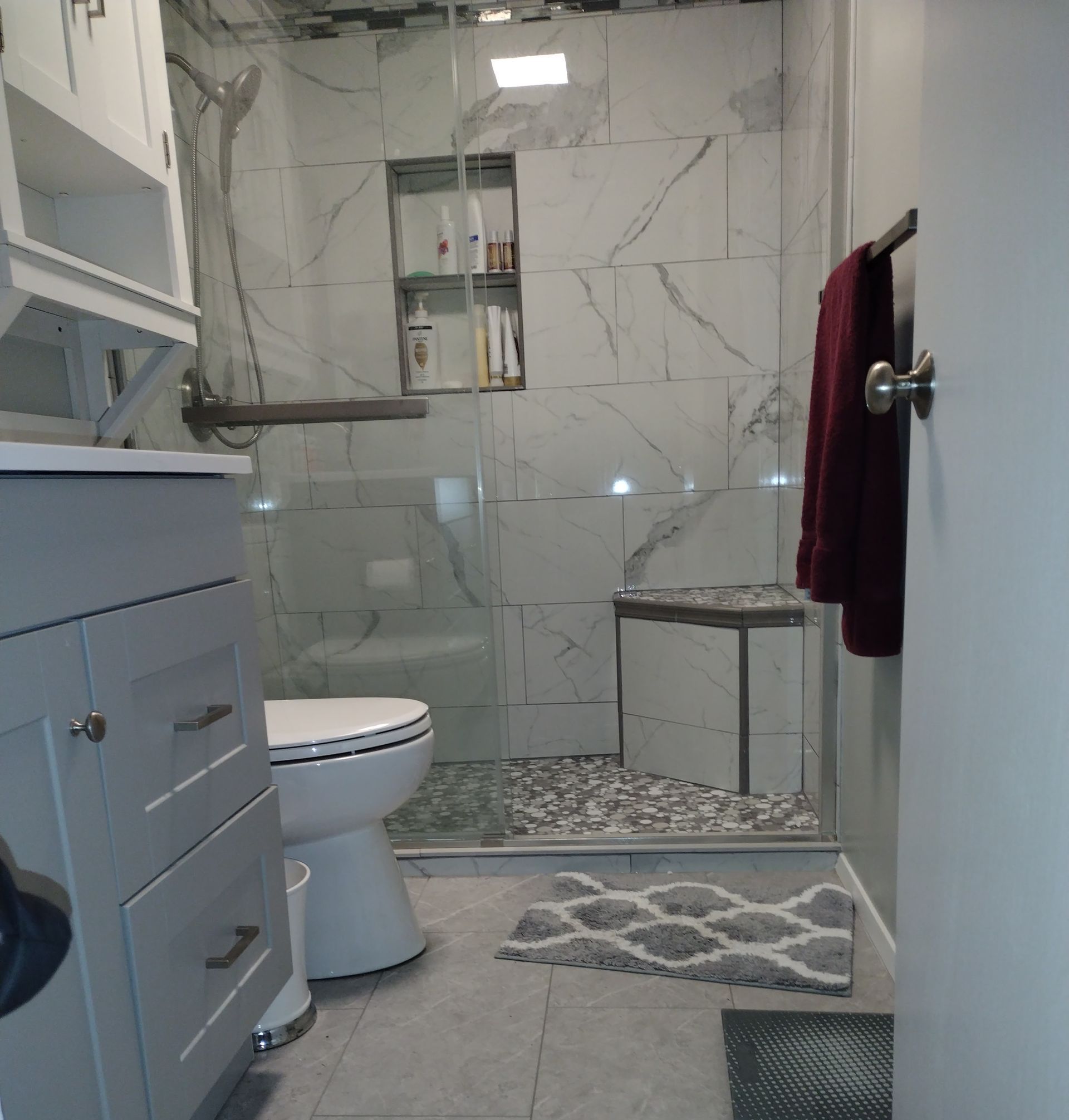 A bathroom with a toilet and a walk in shower