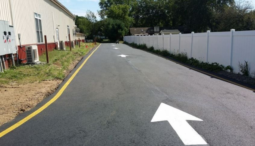A road with a white arrow pointing to the right