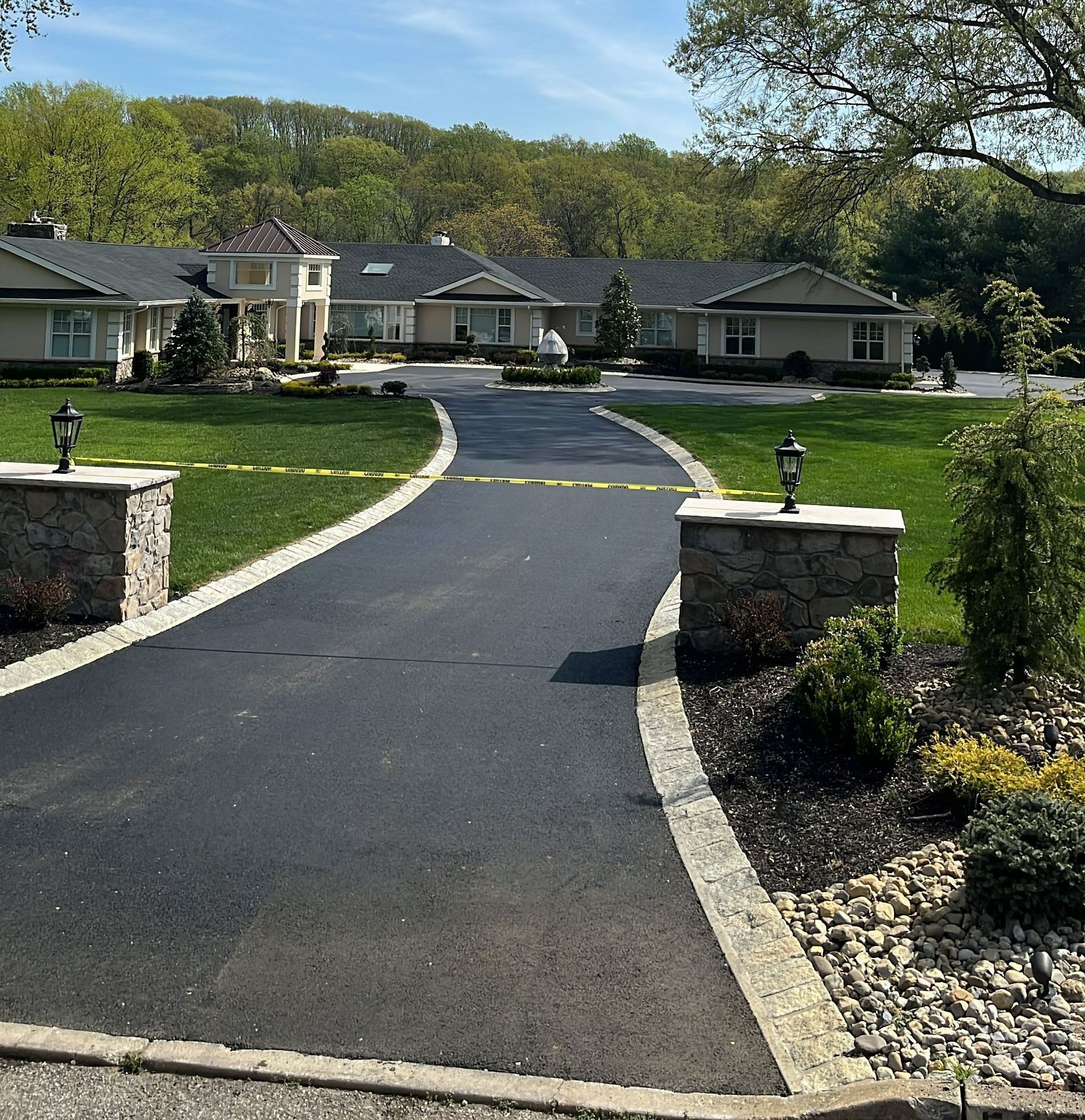 A driveway that leads to a large house