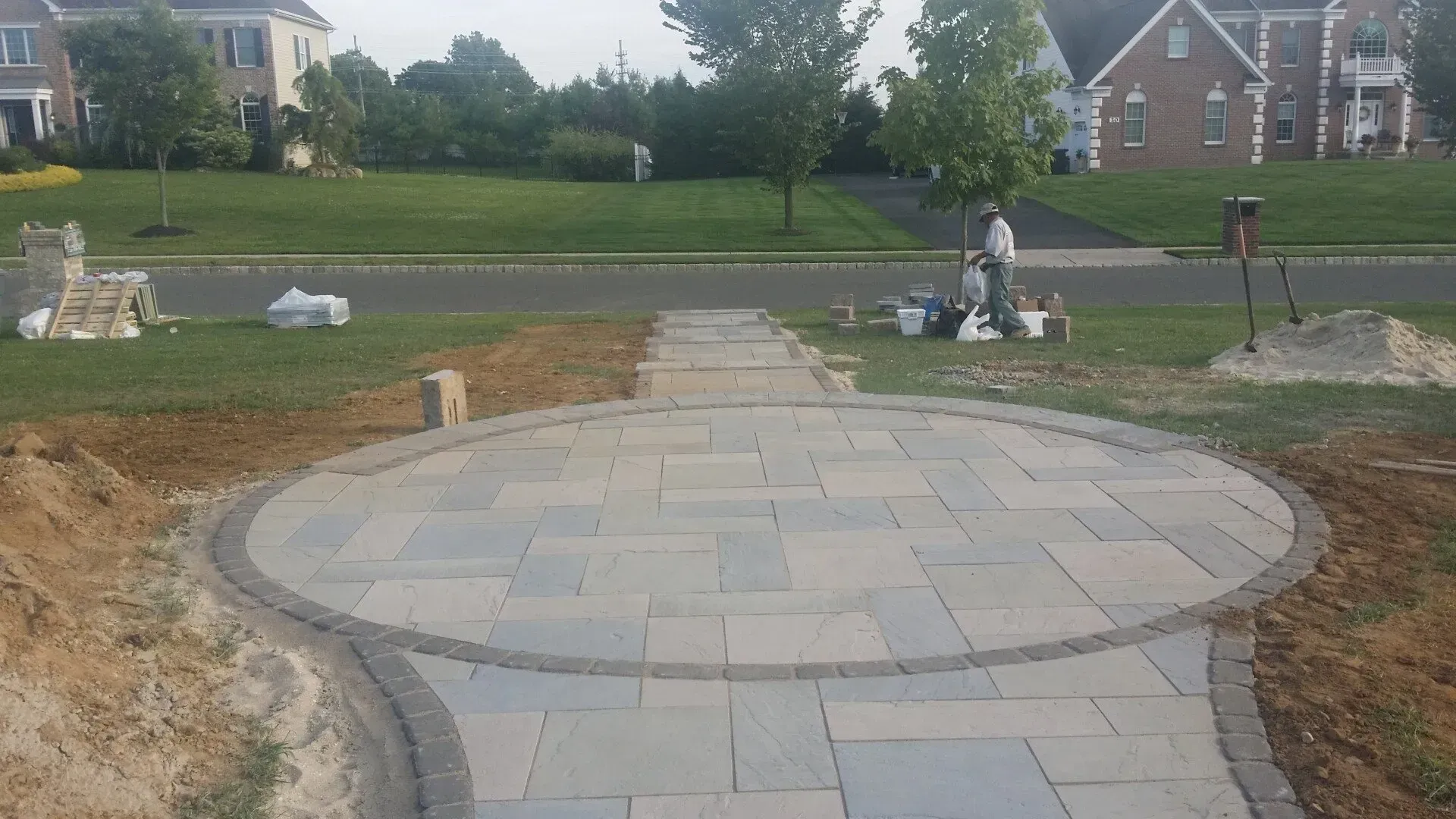 A circular walkway is being built in front of a house.