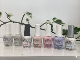 Several bottles of nail polish are lined up on a table — Nail Salon in Airlie, QLD