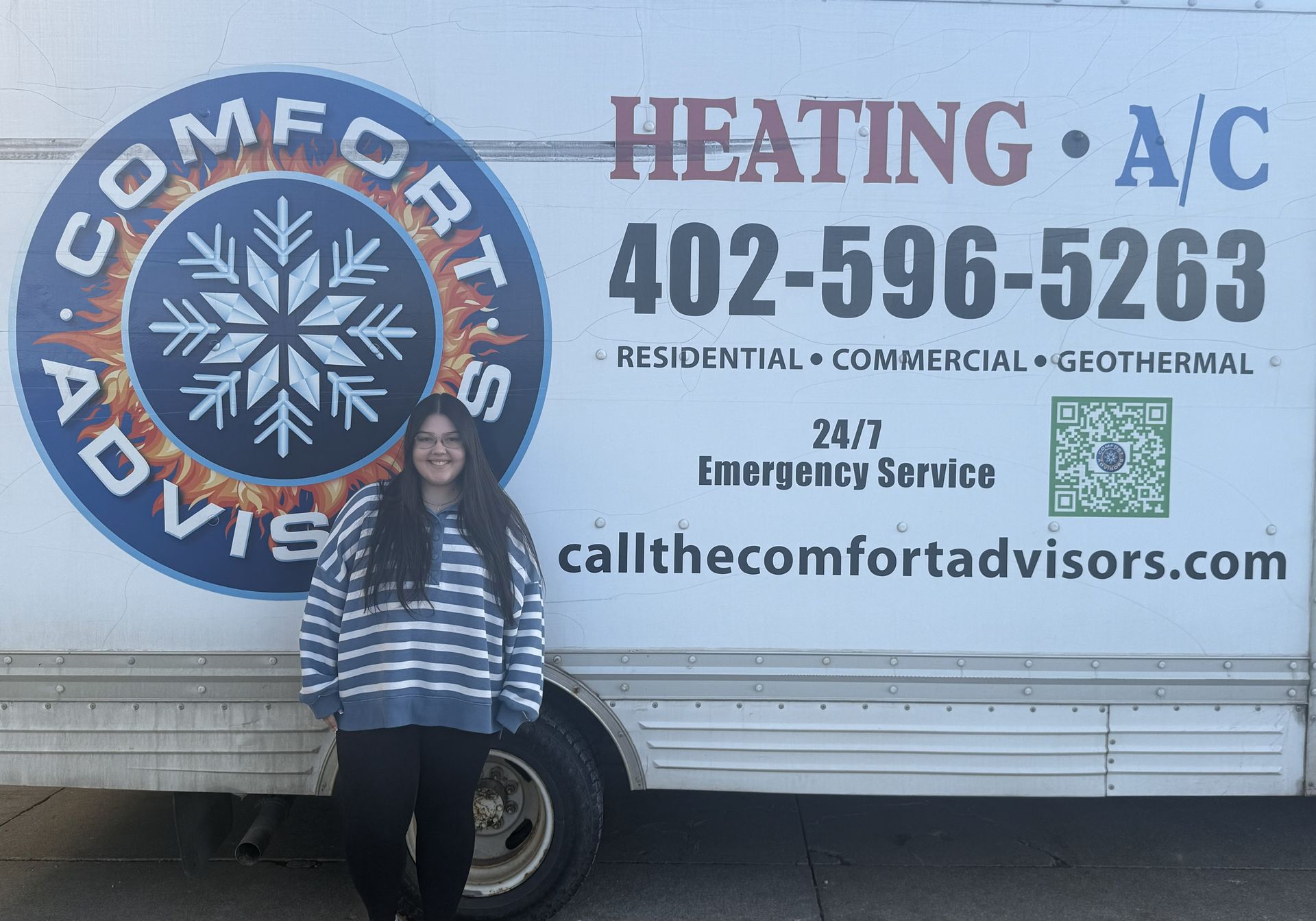 Man in a tan hoodie, short dark hair, looking at the camera. Outdoor setting, neutral expression.